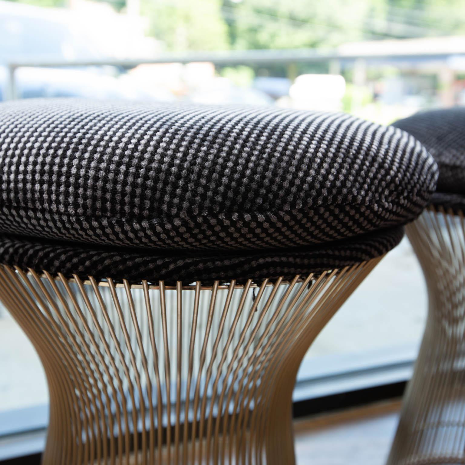 Knoll stainless steel wire stools that have been refinished in a black and grey linear dotted wool fabric.
