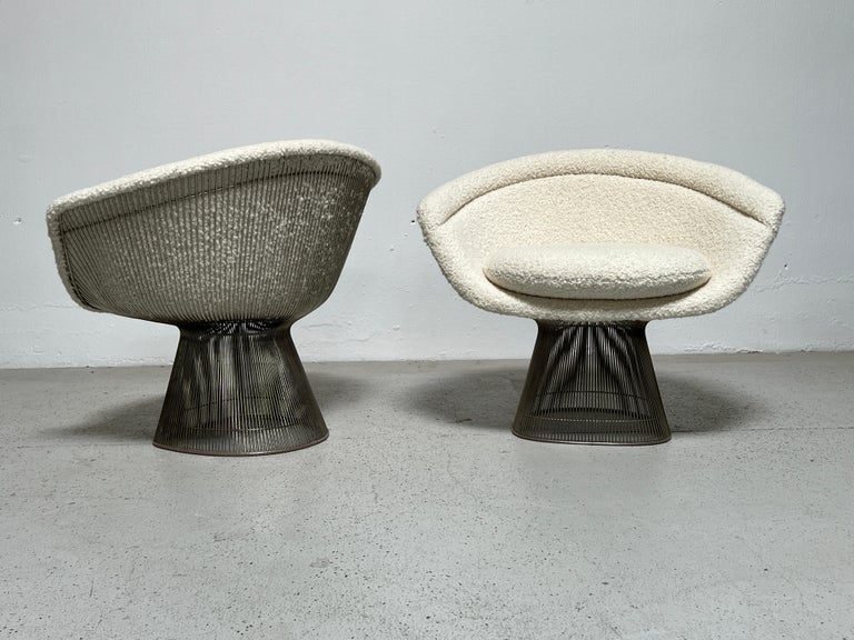 A pair of lounge chairs designed by Warren Platner for Knoll. Nickel plated steel newly upholstered in Holly Hunt / Teddy / Winter White. Two matching pairs available.