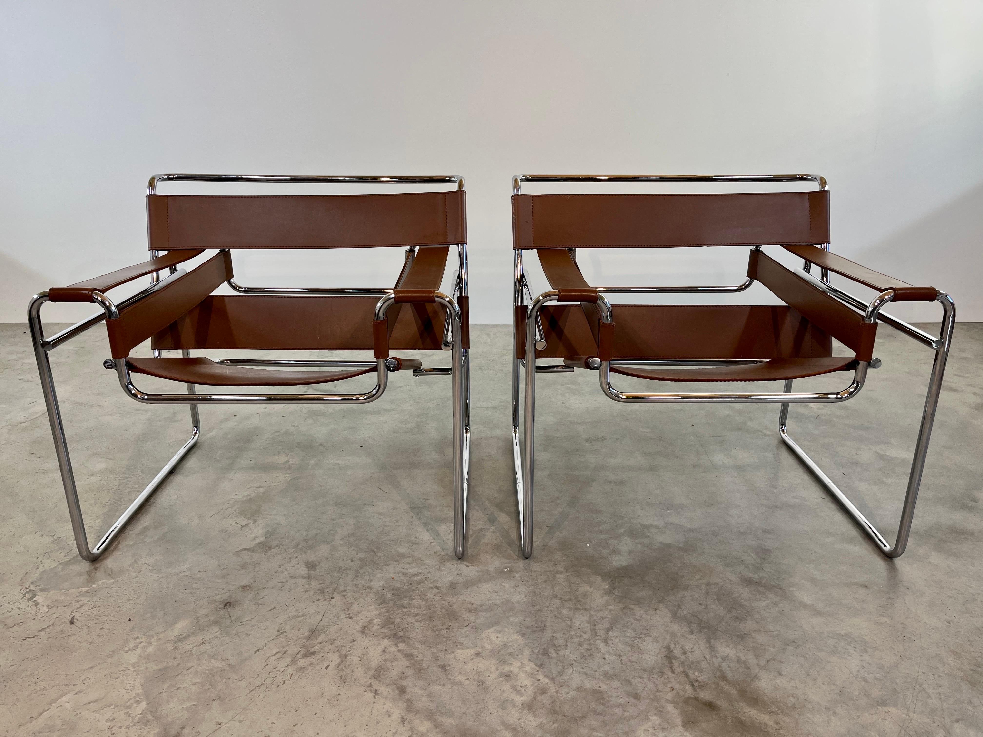 A pair of Wassily Chairs in chocolate saddle leather designed by Marcel Breuer (1902-1981) and manufactured in Italy by Knoll International in 1991. This iconic Marcel Breuer chair was Designed in 1925 and has inspired many designs and designers