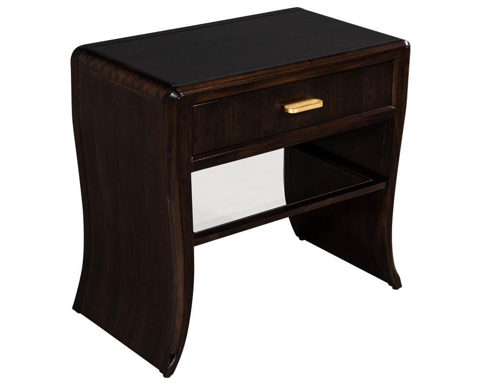 Pair of water fall Mozambique and mahogany nightstands. Waterfall design with single top drawer and clear glass shelf.

Price includes complimentary scheduled curb side delivery to the continental USA.