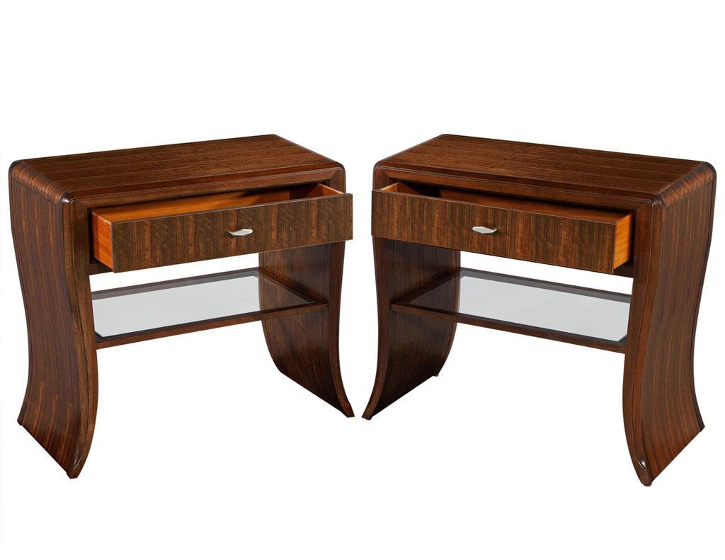 Pair of Water Fall Mozambique and mahogany nightstands. Waterfall design nightstands with single top drawer and open glass shelf. Featuring beautiful detailed wood grains, finished in a rich red mahogany color in satin sheen. Price includes