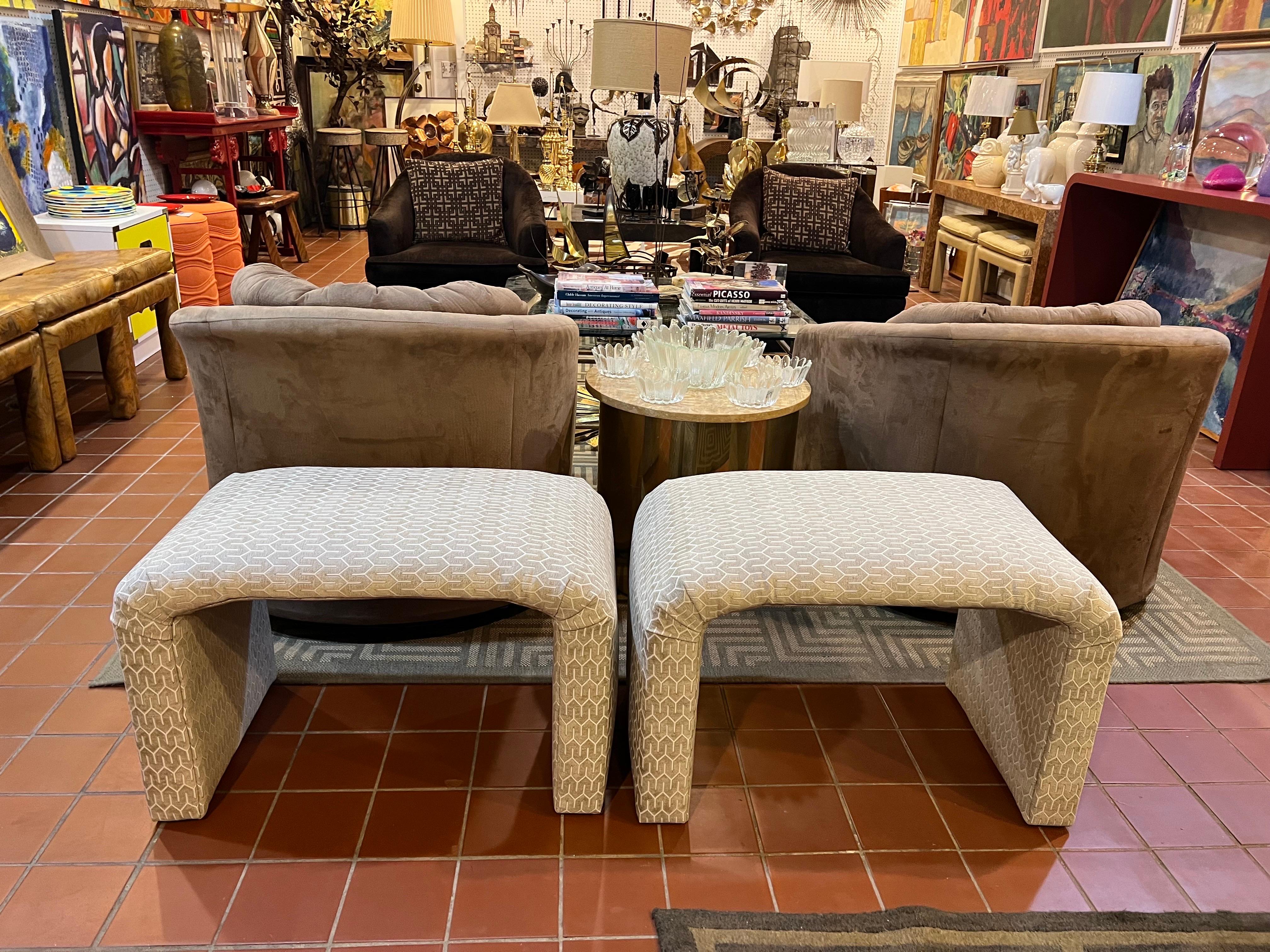 Pair of Waterfall Ottomans in Cream. Newly recovered. Post modern shape with a timeless design. Use pair under a console or at the foot of a pair of twin beds. 