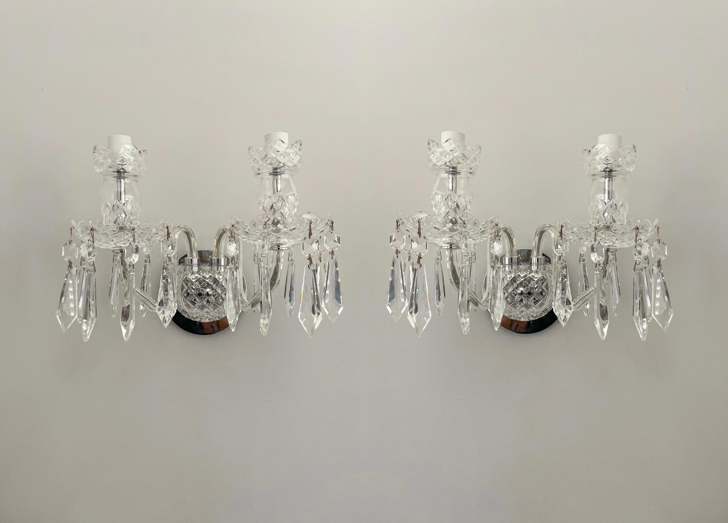 Gorgeous, pair of “Avoca” crystal sconces by Waterford Crystal. 

These fine sconces feature a classic cut crystal design mounted on chrome backplates that can easily be place in traditional European or contemporary settings.

Each crystal