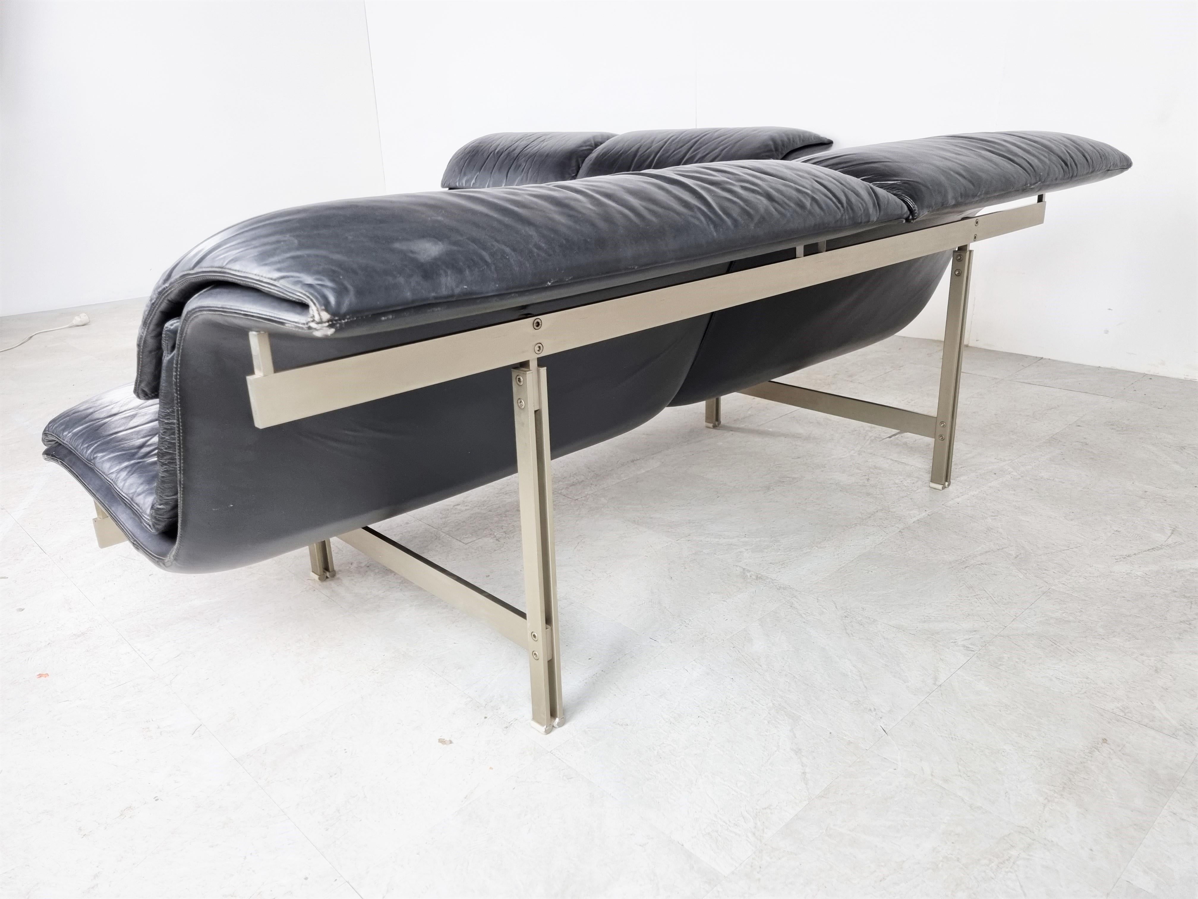 Pair of 'Wave' sofas designed by Giovanni Offredi in 1974 for Saporiti Italia.

Beautiful timeless design with black leather upholstery and and a sturdy steel frame.

Very comfortable sofas.

Good overall condition with normal age related