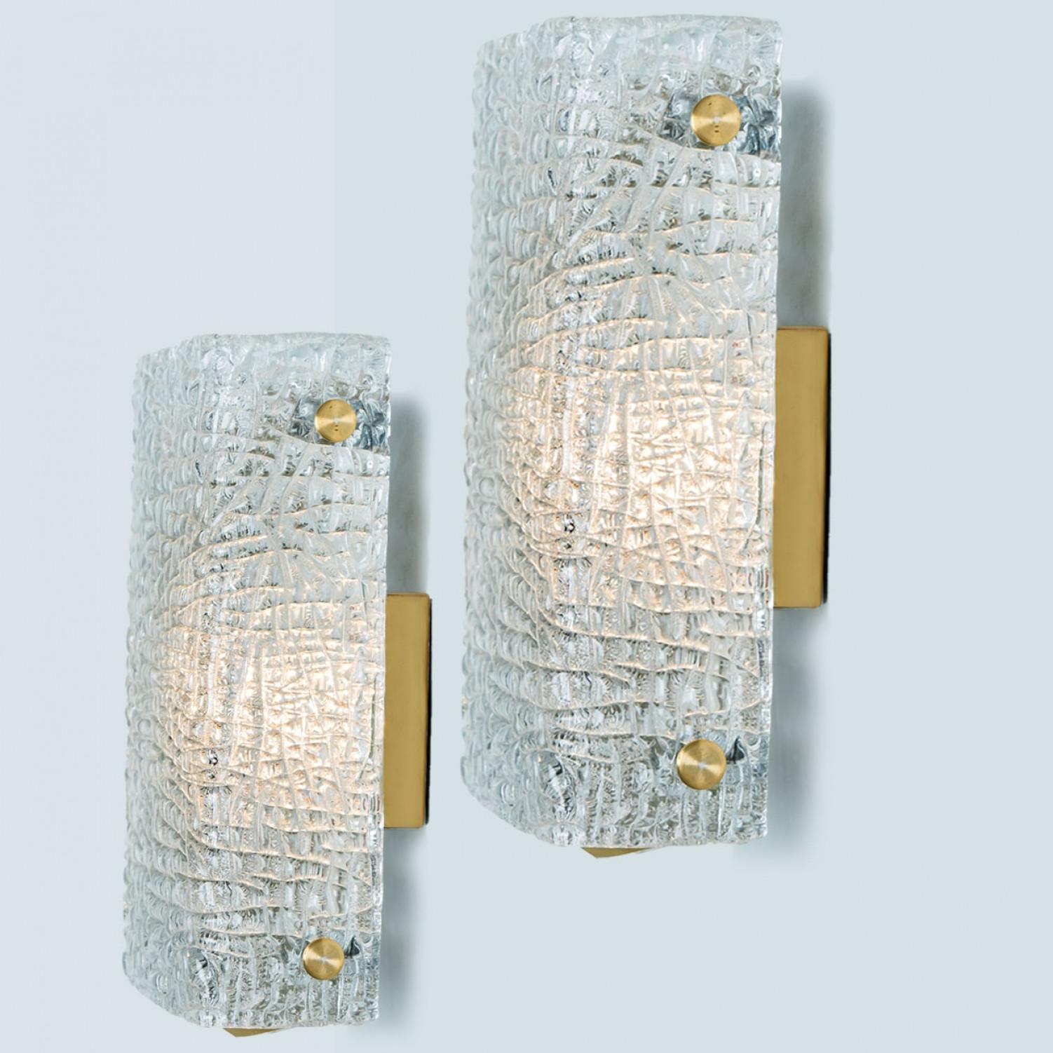 Set of beautiful high quality light fixture made by Kalmar, Austria. Manufactured in mid century, circa 1970 (at the end of 1960s and beginning of 1970s).

This wall light features lights made of handmade wave ice glass and brass back plate. The