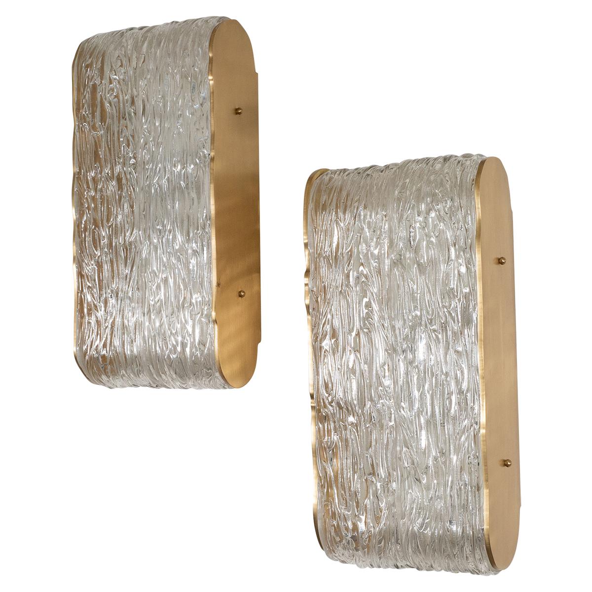 Pair of wavy textured glass sconces with ovoid brass frames in the style of Kalmar.