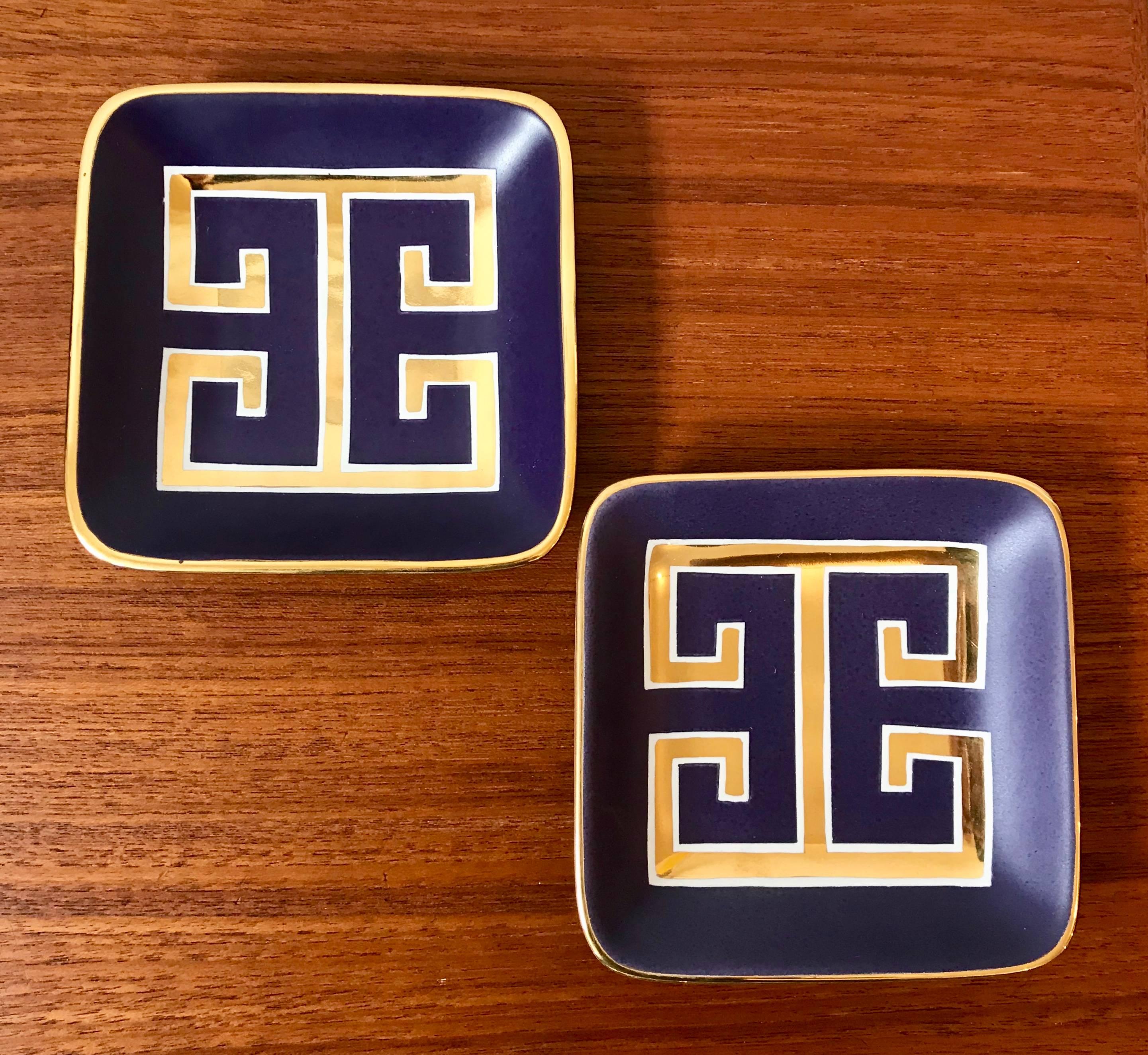 Pair of small trays or decorative square trinket dishes by Waylande Gregory. Vibrant matte purple glaze with 24-karat gold key pattern. Classic design by Gregory but newer production.