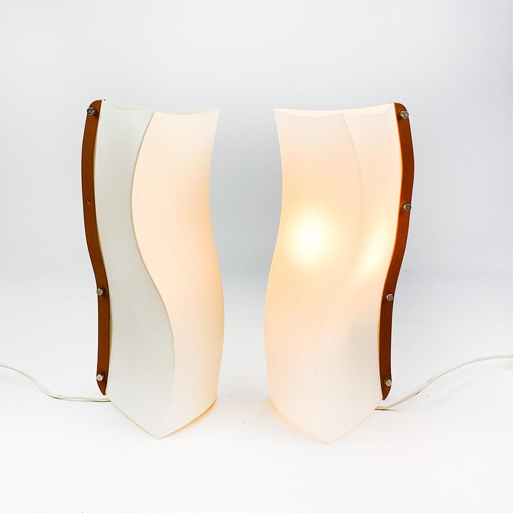 Pair of WB-Small lamps design by Giulio Di Mauro for Slamp, 1980's.

Opalflex body and side in leather joined by polished aluminum screws.

One of the lamps is missing one of the screws.

Both have European plug, switch and intensity