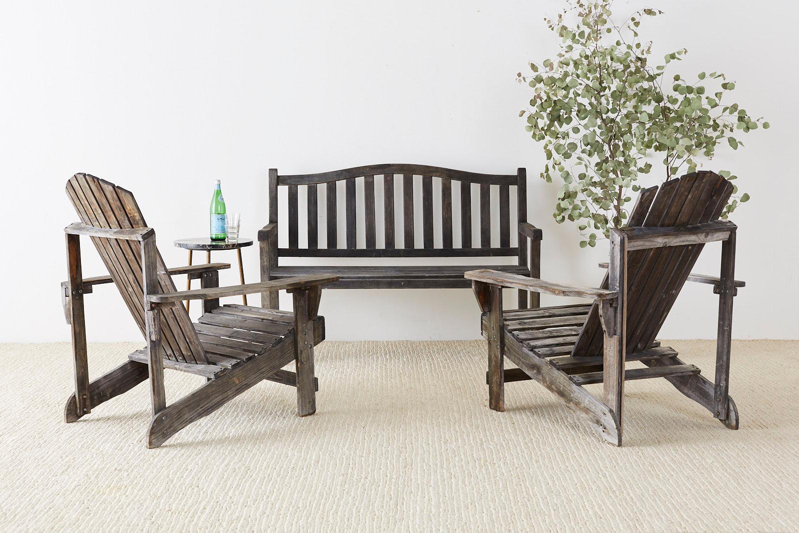 Classic pair of Westport plank chairs or Adirondack chairs with a beautiful distressed, and weathered patina on the wood. Featuring a slightly concave back style which was patented in 1938. From an estate in Malibu, CA.