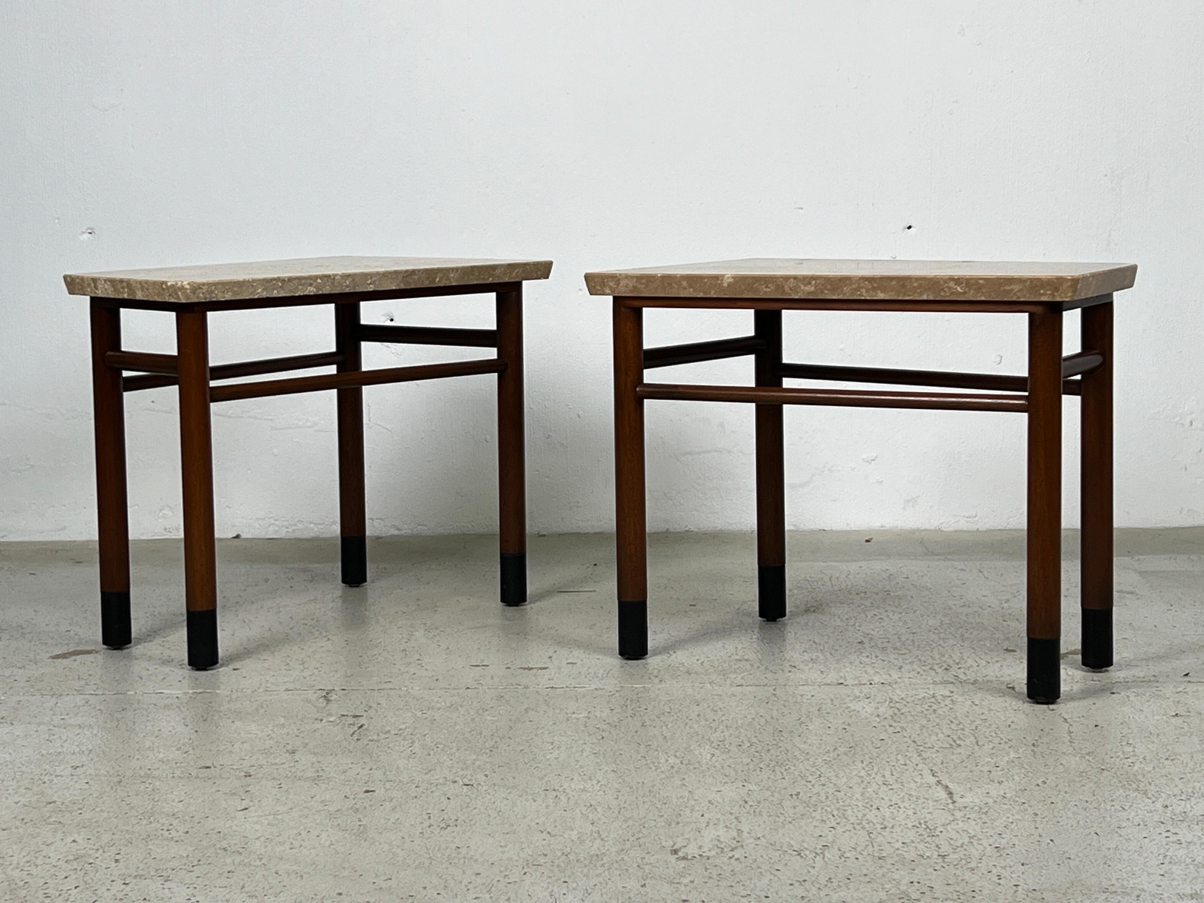 A pair of wedge shaped travertine top tables with mahogany bases and leather wrapped feet. Designed by Edward Wormley for Dunbar. 