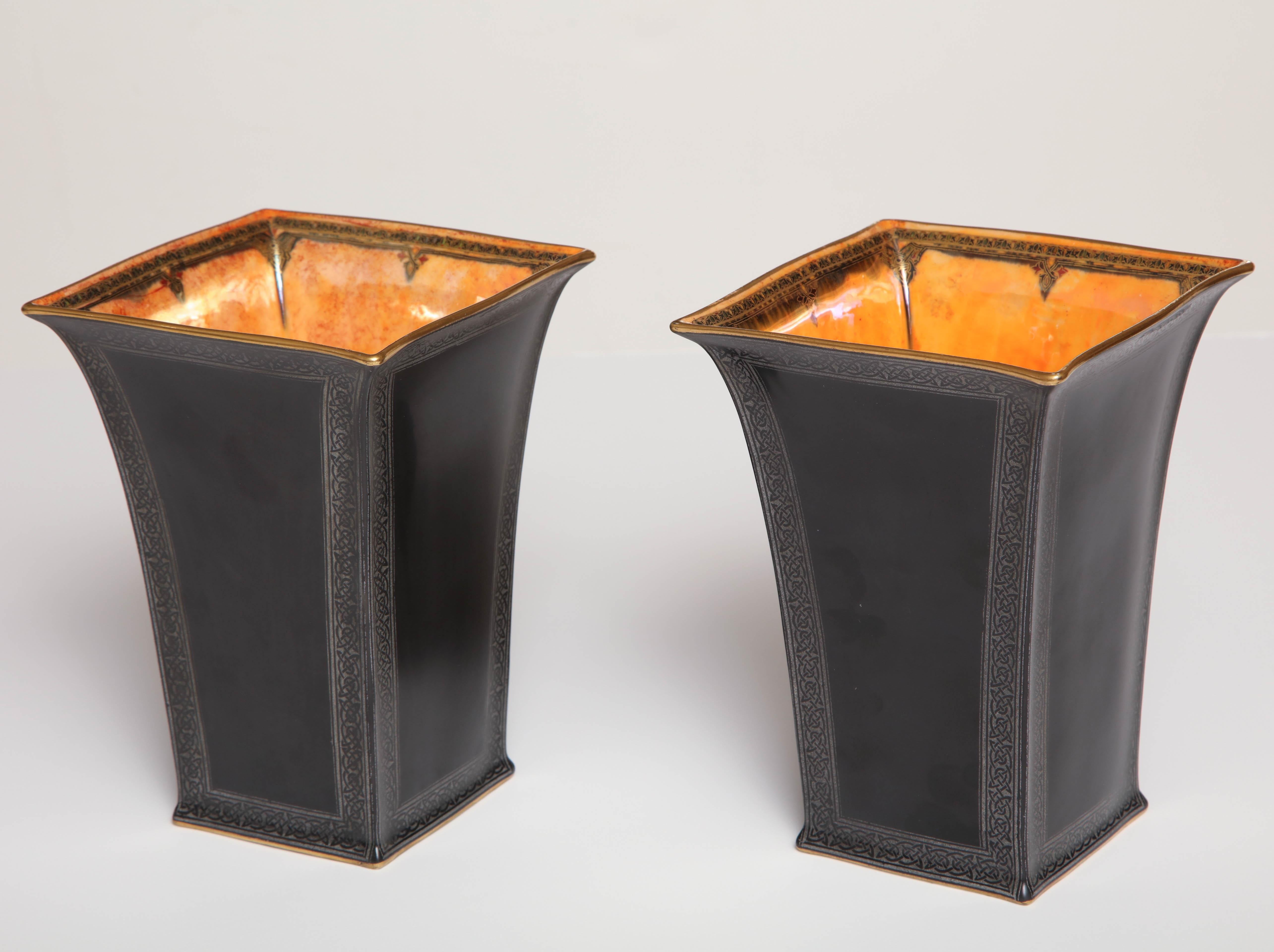 Pair of Wedgwood, black glazed, Lustre ware vases.
Square bone China vases with flaring sides, St. Chads bead border printed in silver. The interior with Celt border to an orange Lustre ground.
England, circa 1920.