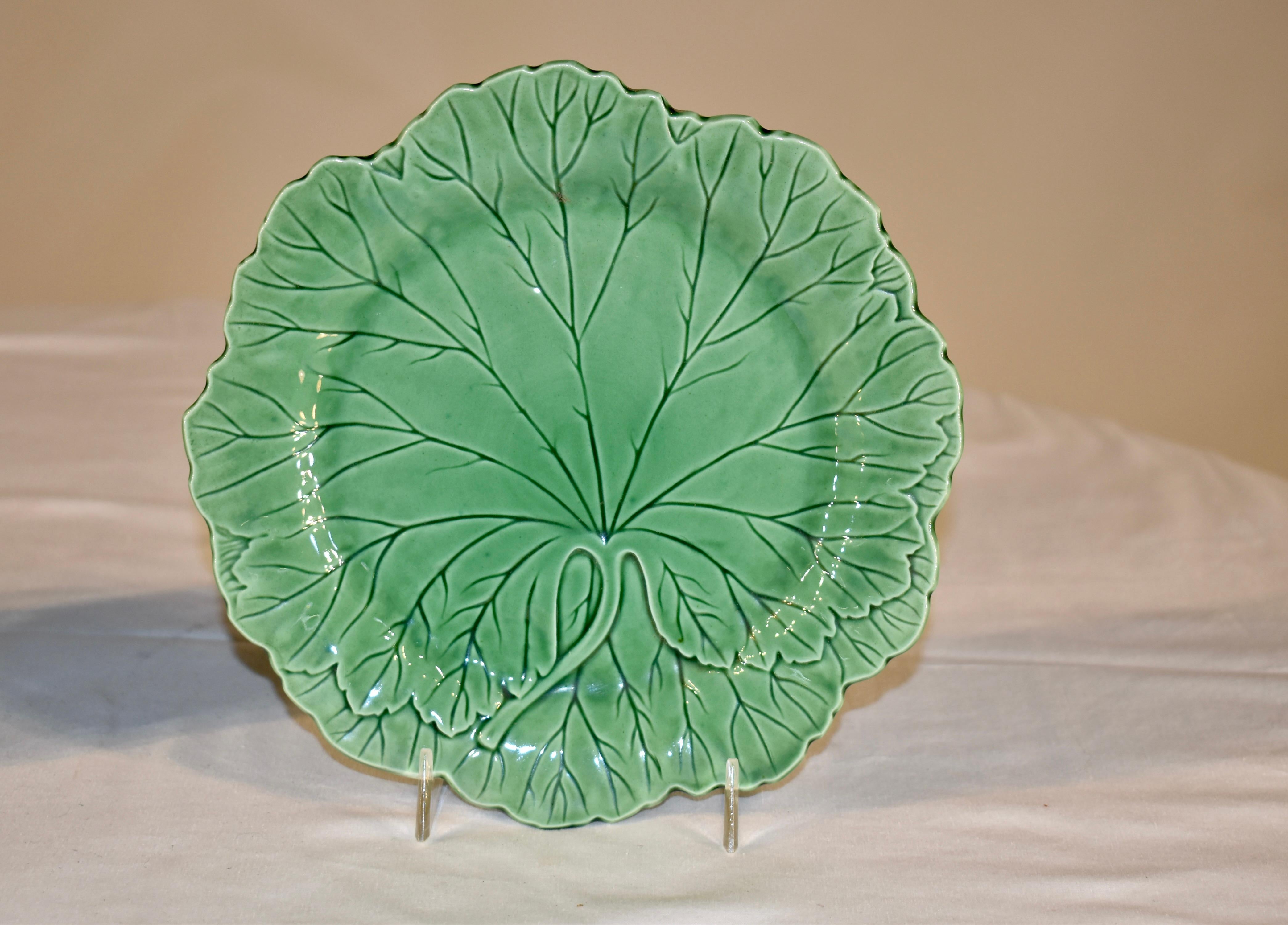 Pair of majolica glazed green leaf plates marked on the back with WEDGWOOD, made in England and the date mark for 1952. Lovely color. Plate stands not included.