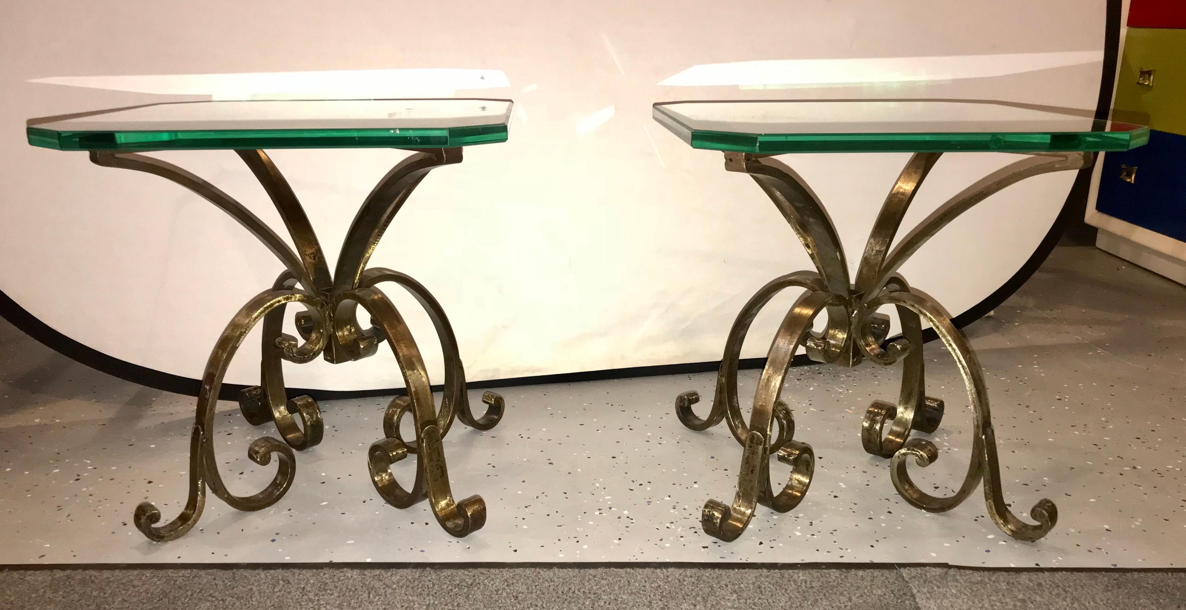 A pair of welded steel end or pedestal tables having 3/4 inches tops glass. Each handcrafted end or pedestal table is crafted in a hand hammered manner with swirls and scroll designs. Placing these 18 inch tables together would make a beautiful