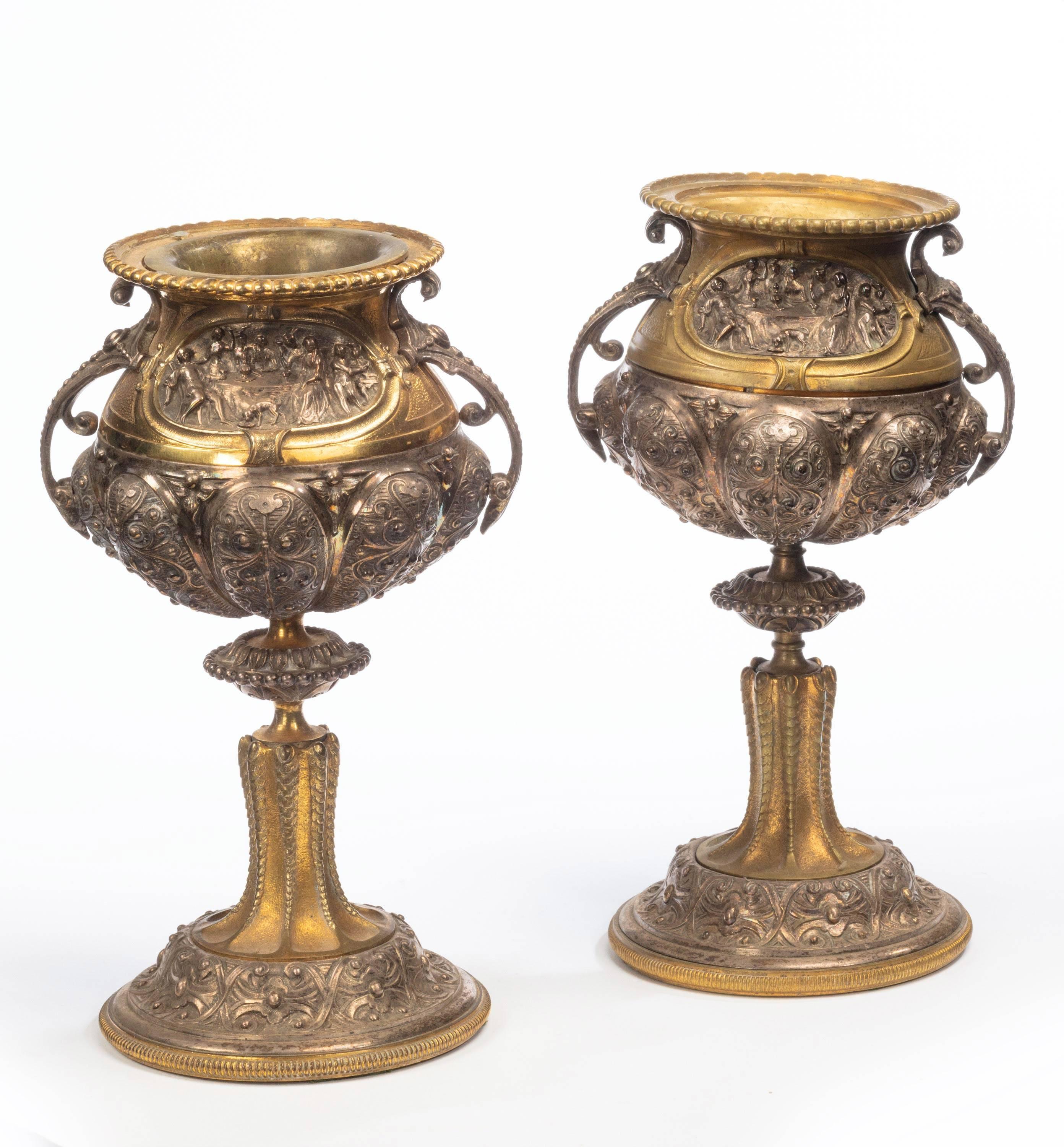 A pair of 19th century well-cast and elaborate gilt bronze and bronze vases of cup form. With very elaborate decoration. Now well and evenly patinated.
     