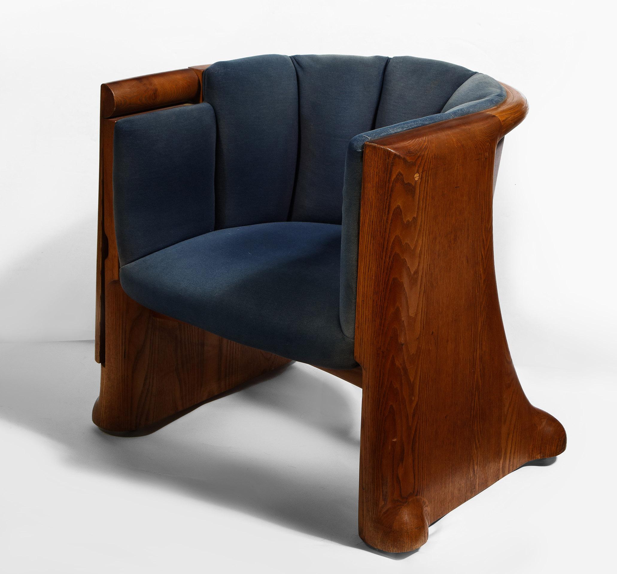 Carved Oak with each chair featuring a flip-top writing surface.
Provenance: The chairs designed for the boardroom of the Gannett Company in Rochester, NY. 
Literature: Eerdmans, Wendell Castle: A Catalogue Raisonné 1958-2012, 2015, p. 129.