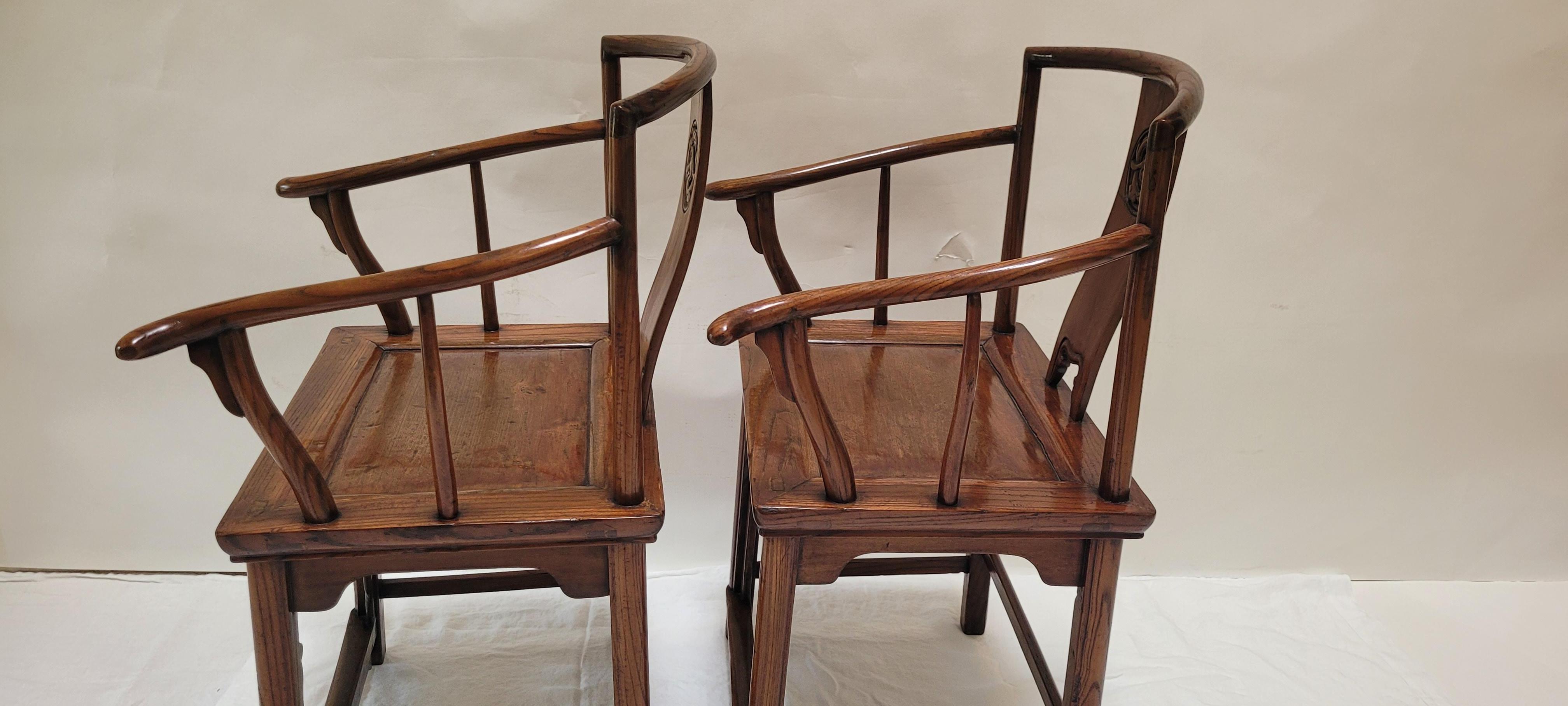  Pair of Wenyi Armchairs	37.25h x 22w x 16.75d
This is a pair of Wenyi (scholar) armchairs.  The crestrail does not have any protruding ends, but the arms do.  This pair is considered a bit unusual as the supporting stiles under the arms are not a