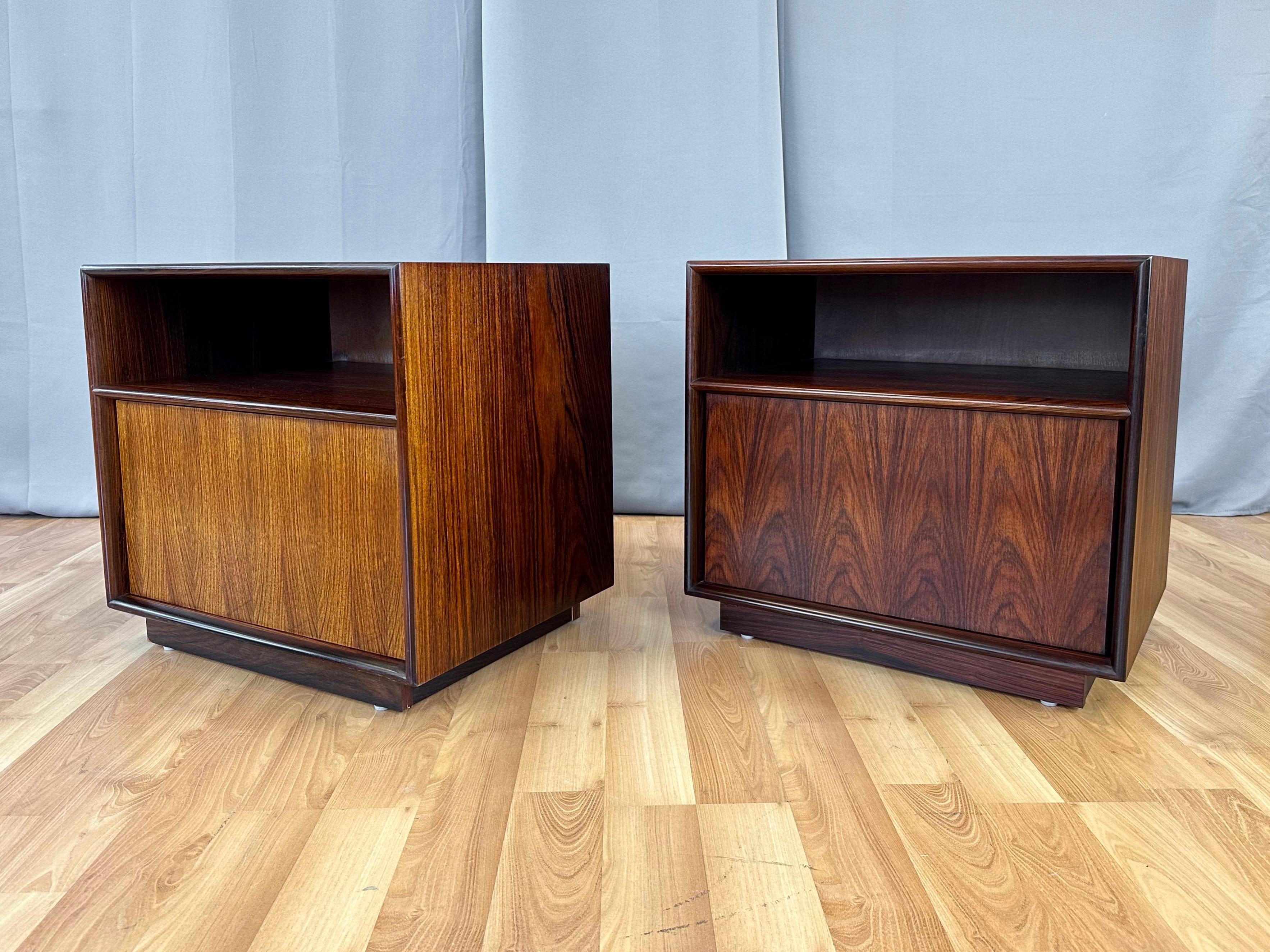 A pair of very handsome and uncommon circa 1970 Westnofa-style Norwegian rosewood nightstands with door and cubby.

Timeless and clean Scandinavian modern design features an upper cubby and a lower cabinet with push-to-open spring-action door.
