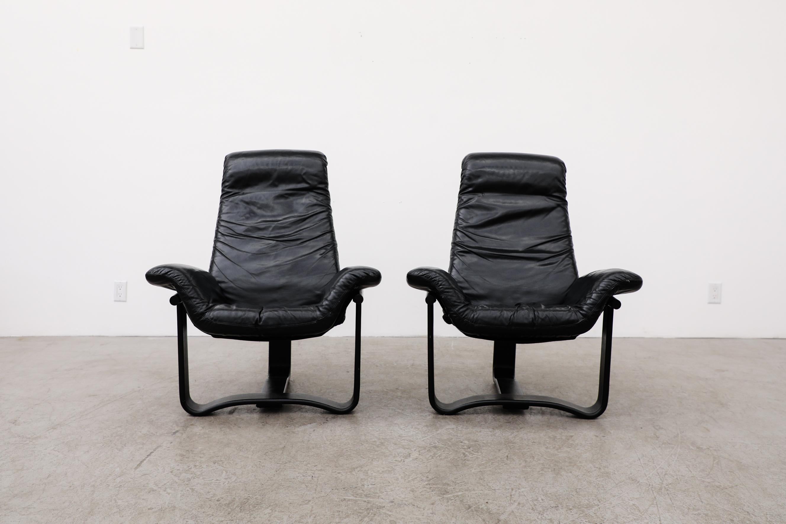 These 1960's-70's Westnofa lounge chairs have a black bentwood frame with mesh sling support and black leather cushions. Both chairs are in good original condition with normal wear to leather and wood frames. Set price.