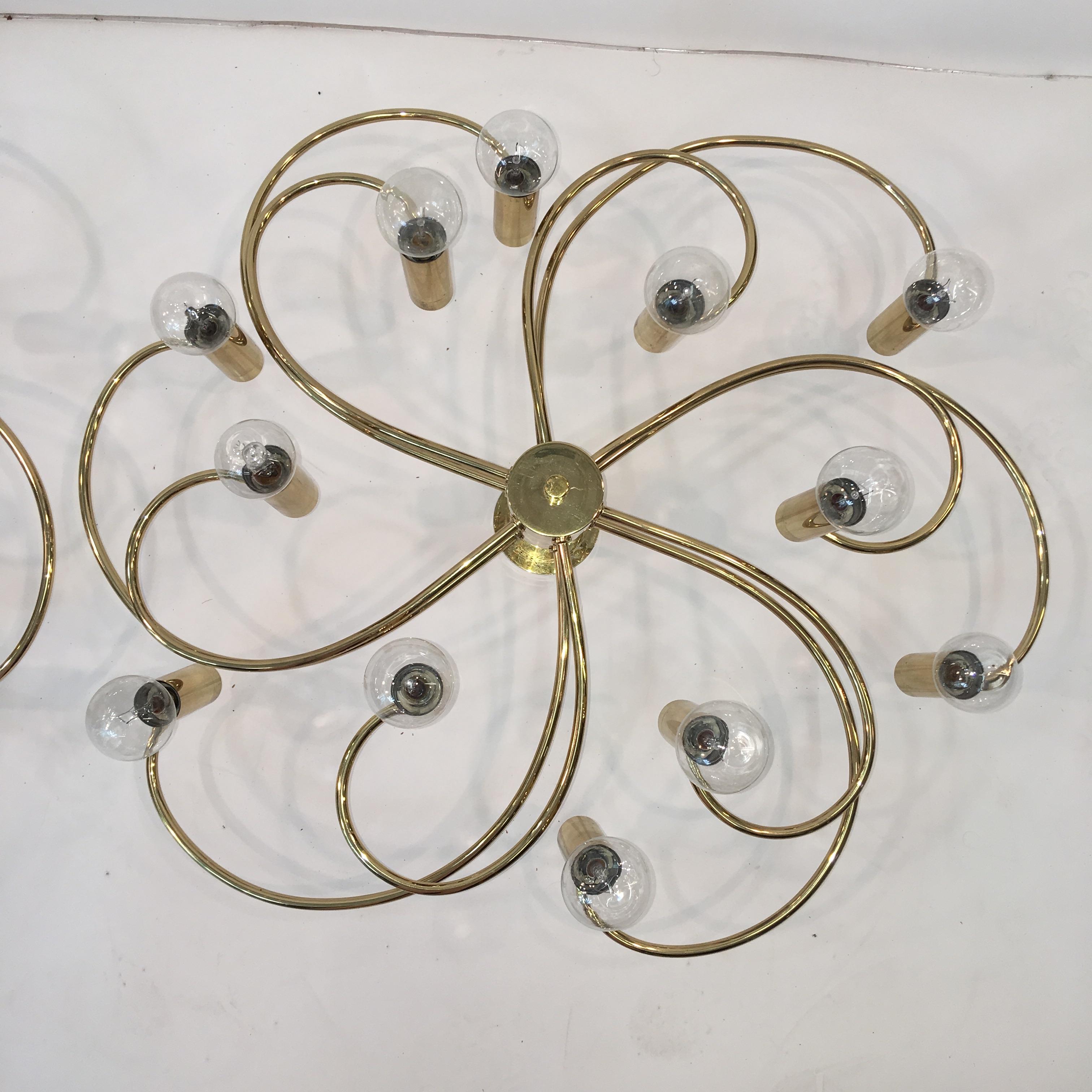 Pair of vintage 1960s pinwheel form brass ceiling or wall mounted light fixtures. Produced by Cosack Leuchten and designed by Hans Wilfried Hegger (sometimes H. W. Egger).  
Each socket takes a single candelabra size screw cap bulb (E14 or E12) up