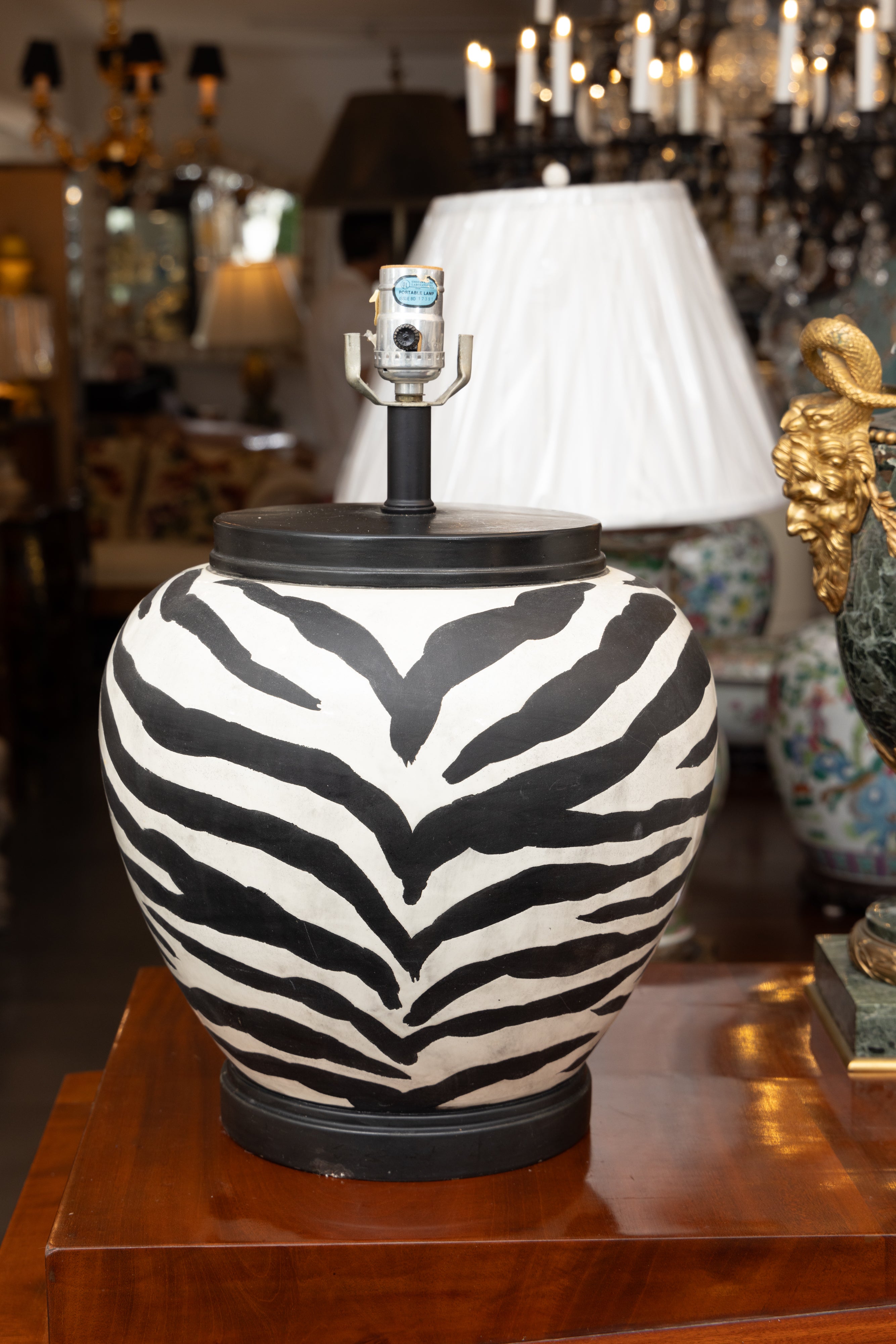 This is a whimsical pair of ceramic zebra print melon-form lamps with rosewood caps and bases.