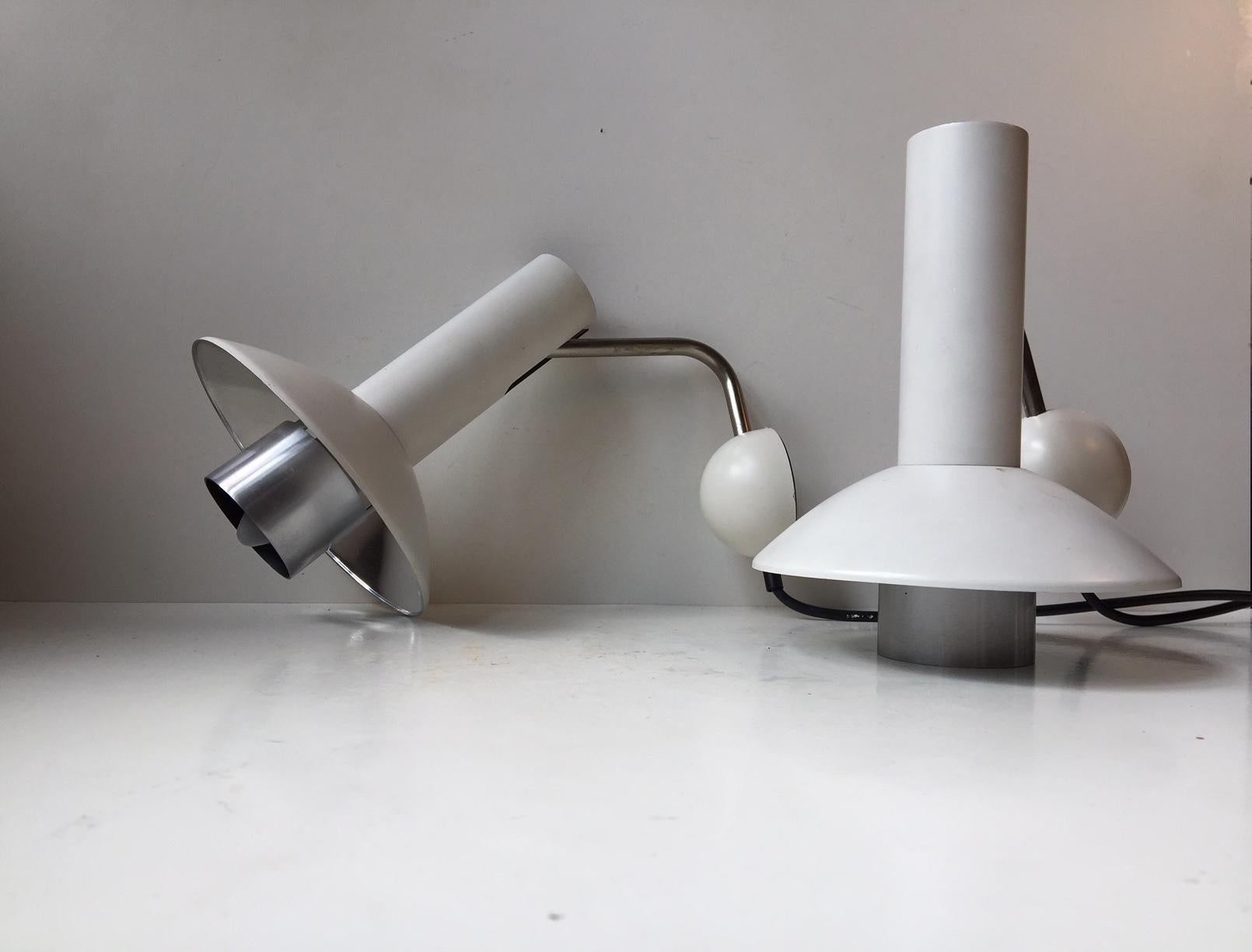 A pair of rare white wall lights designed and manufactured by Louis Poulsen in Denmark during the 1970s. This model: 132051 - is called 'Louise' and is obviously derived from Louis in Louis Poulsen. They are fully adjustable - up/down and side to