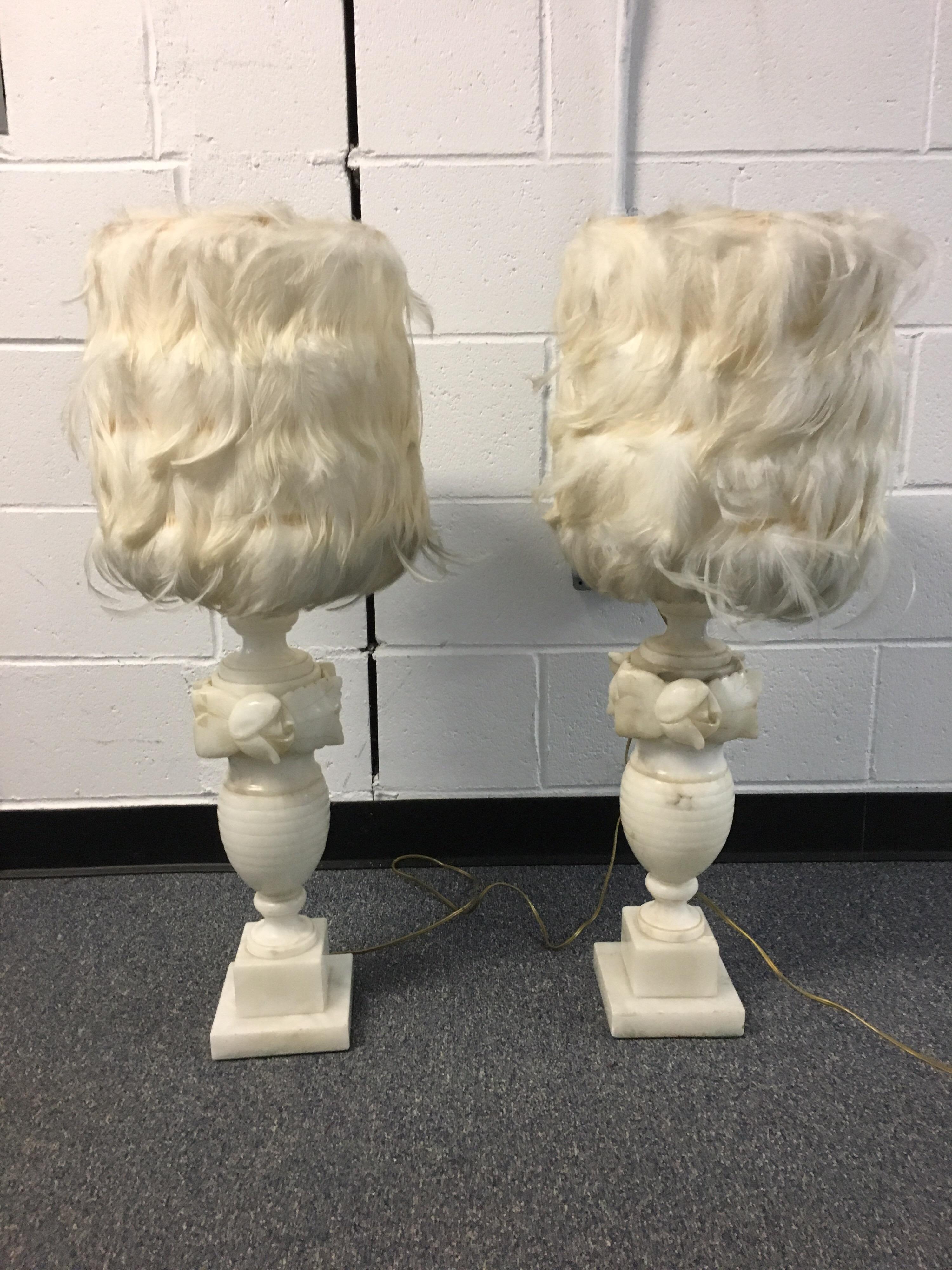 Pair of white Alabaster carved lamps with custom feather shades. Carved flower and urn shaped lamps. Cream feather lamp shades. Both working well.

Overall height with shade: 10.25