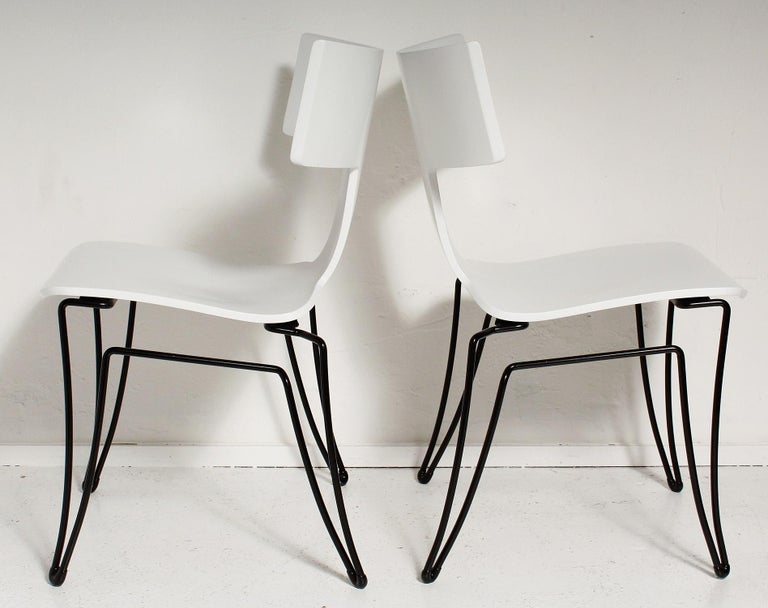 Klismos-style Anziano chairs, designed by John Hutton for Donghia, circa 1985, with newly restored white molded beechwood seats with black powder-coated tubular steel frames and original black rubber floor protectors. Chairs are priced individually