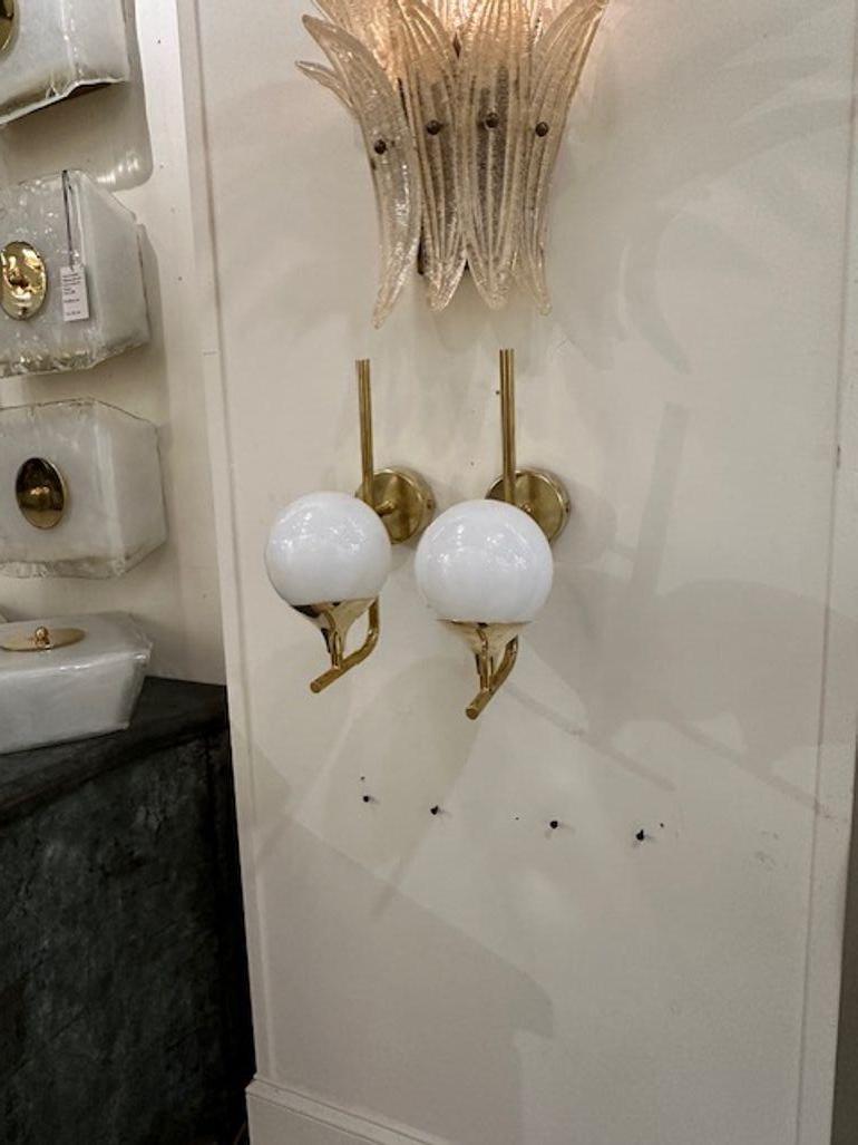 Nice pair of white Murano glass ball form sconces on a polished brass base. Simply beautiful!