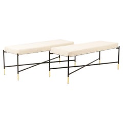 Pair of white benches, in lacquered and gold metal. 2000s.