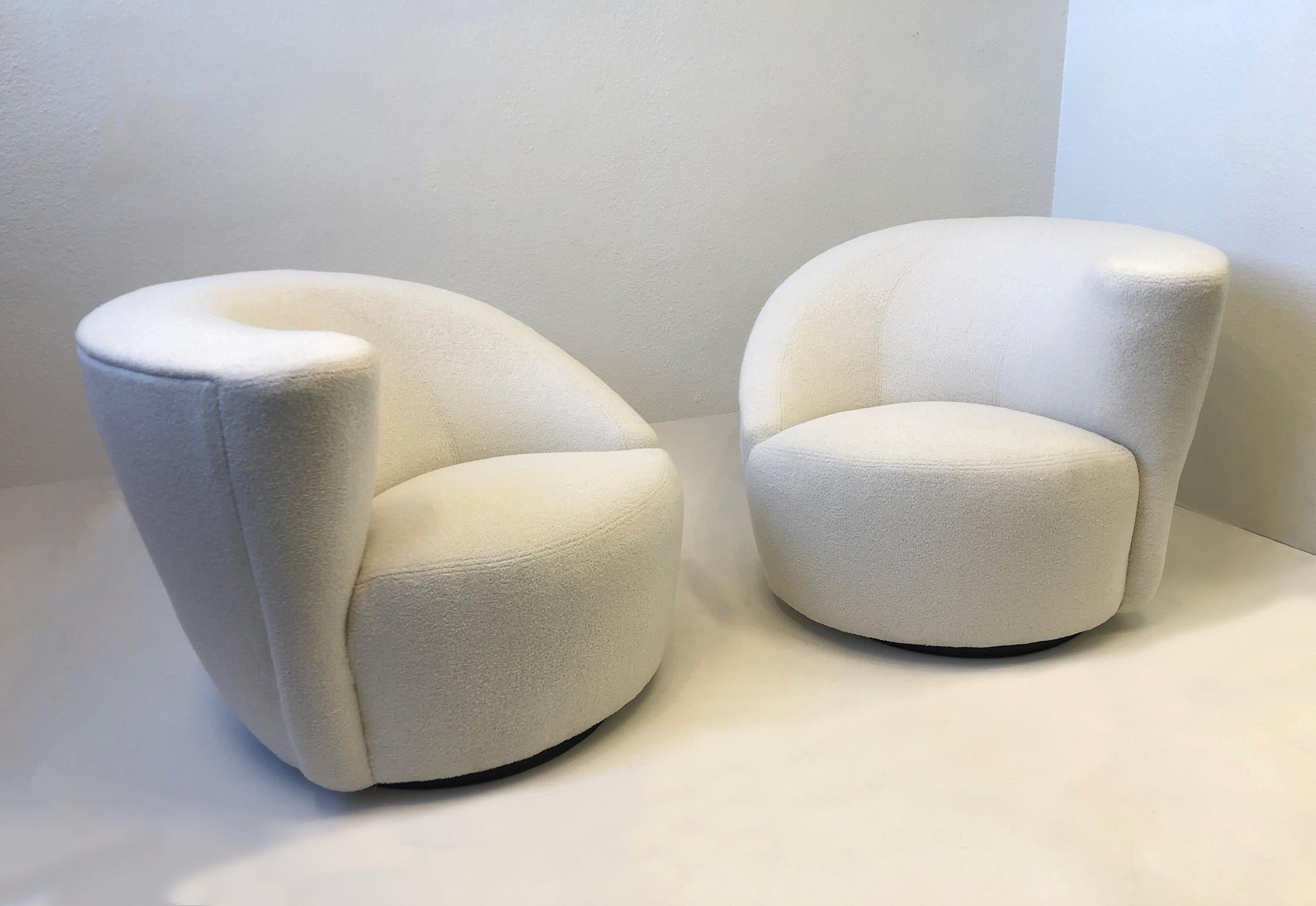 1990’s Pair of ‘Corkscrew’ lounge chairs and ottomans designed by Vladimir Kagan for Directional.
Newly recovered in a soft white boucle fabric. The chairs rotate 180 and return to original position. 
Measurements: 36” Wide, 36” Deep, 29” High,