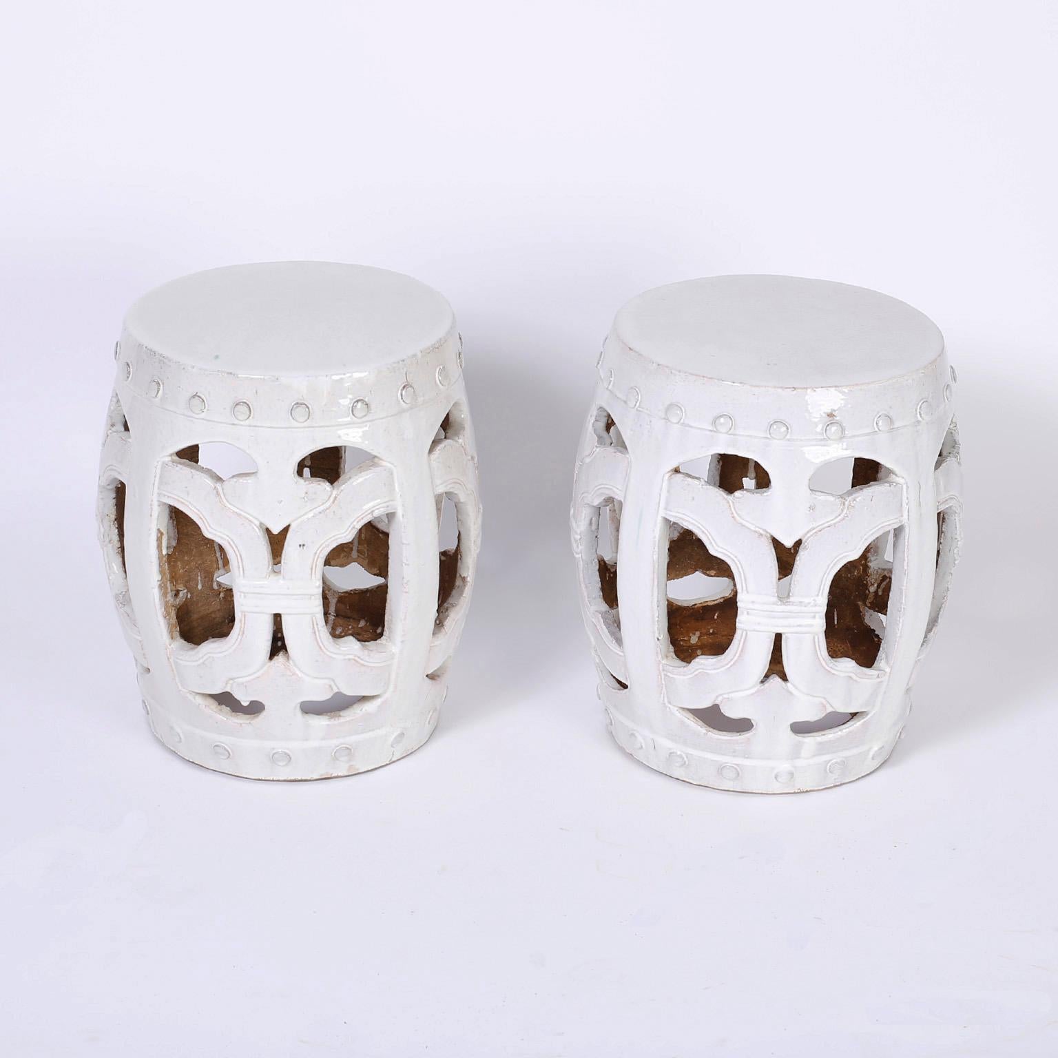 Pair of terracotta Chinese garden seats with an alluring translucent white celadon glaze over a Classic chinoiserie form.
 