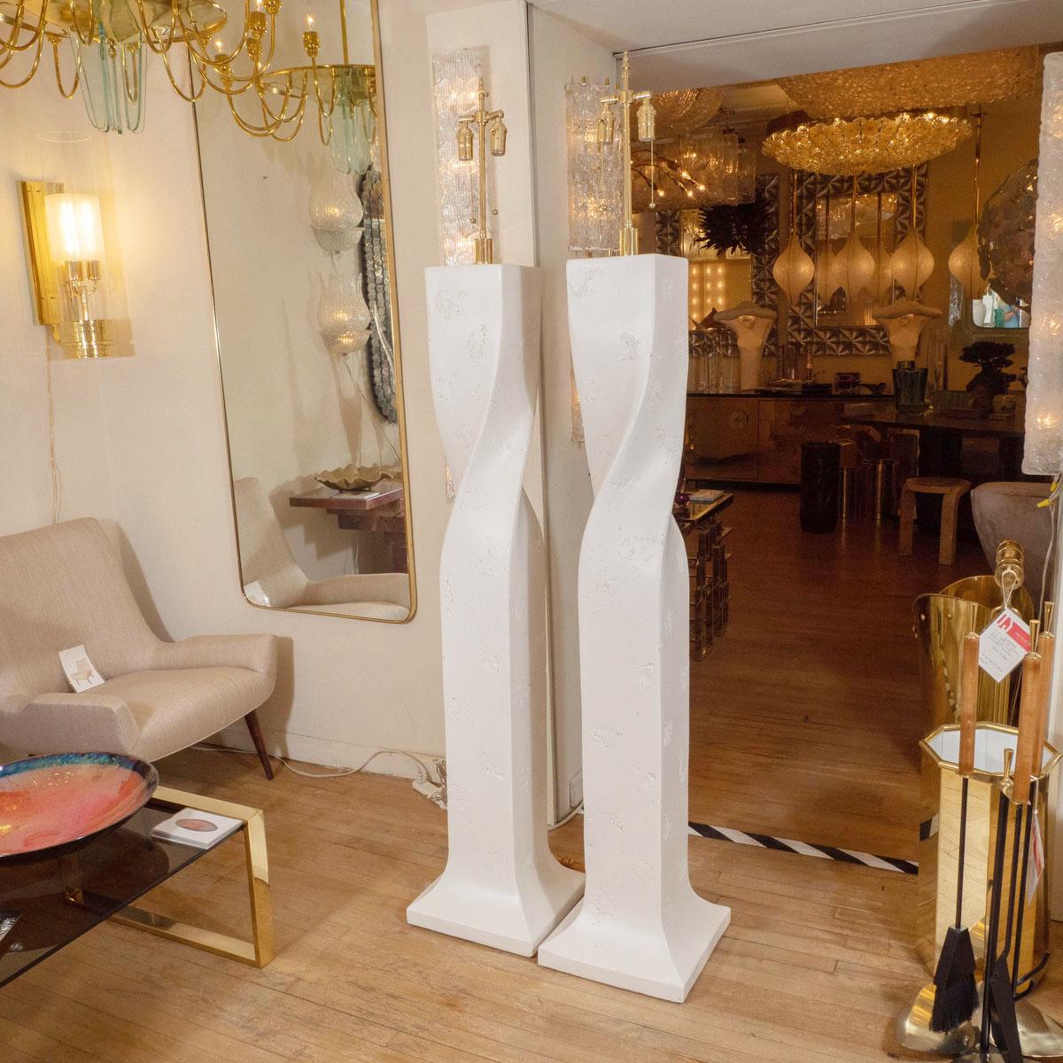 Pair of white composite plaster twisted floor lamps.