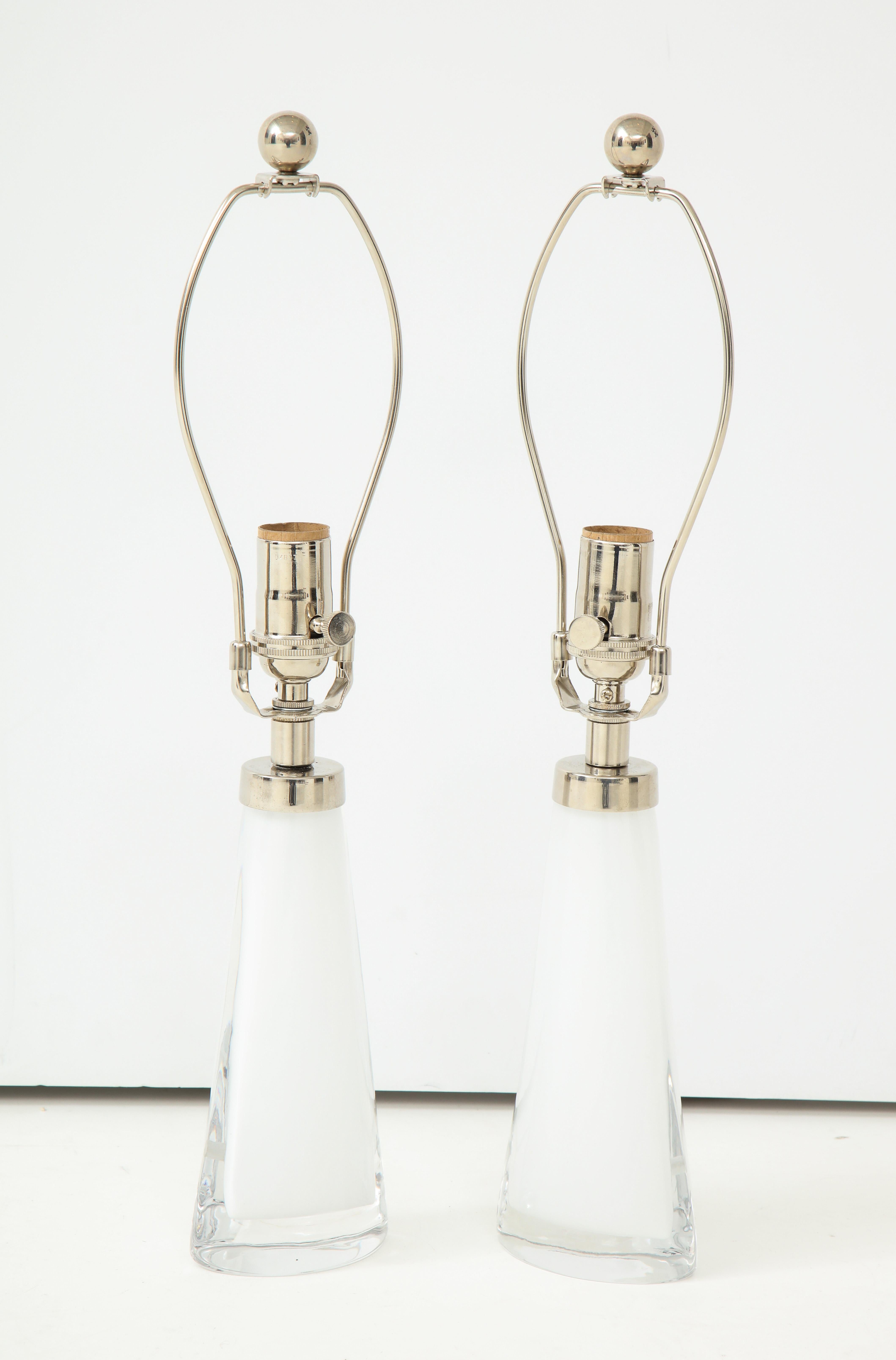 Pair of white crystal lamps by Carl Fagerlund for Orrefors.
The lamps have polished nickel hardware and they have been newly rewired for the US.
Measures: The height to the top of the glass is 9