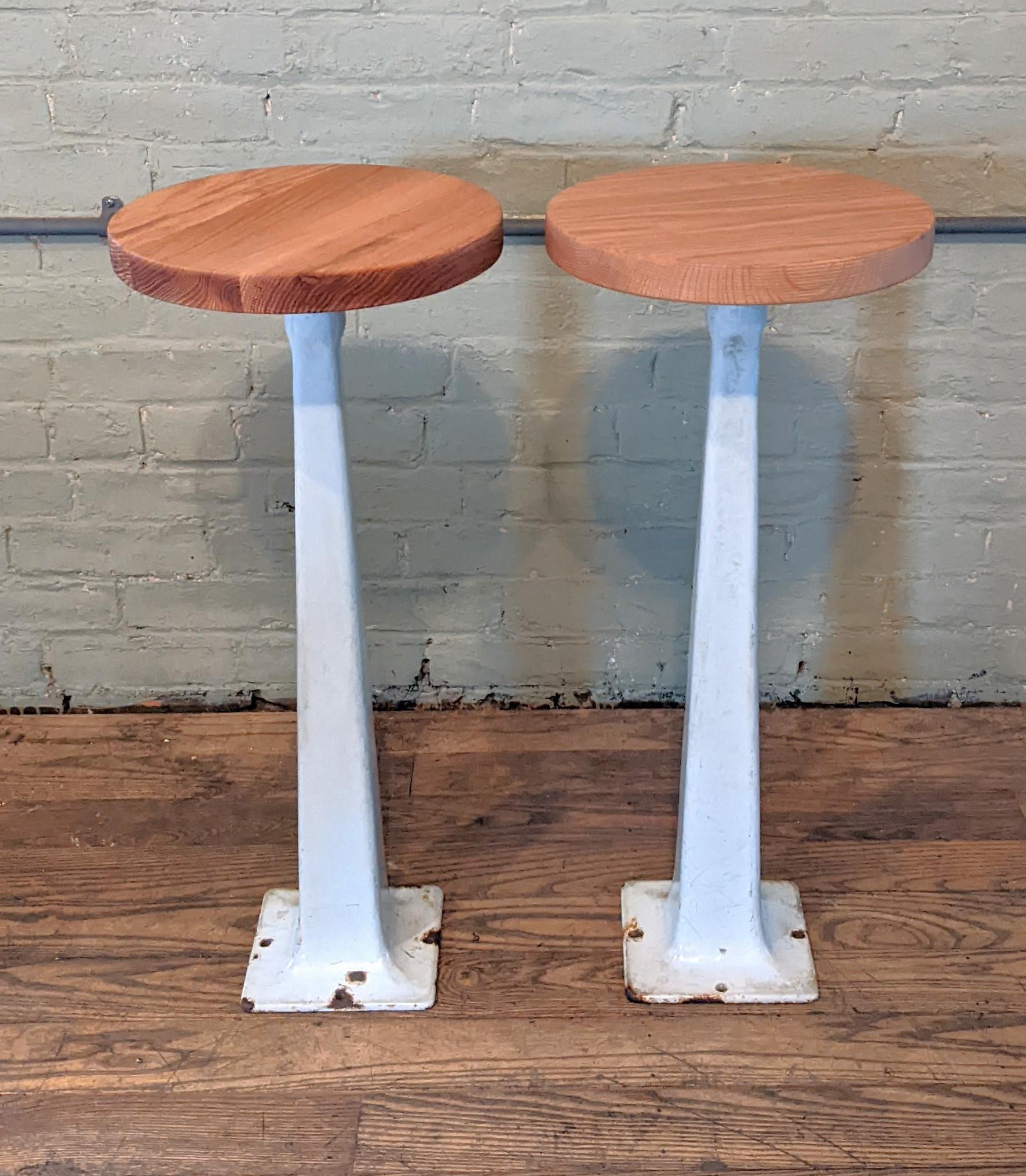 White diner stools with oak seats.

Seat height: 28