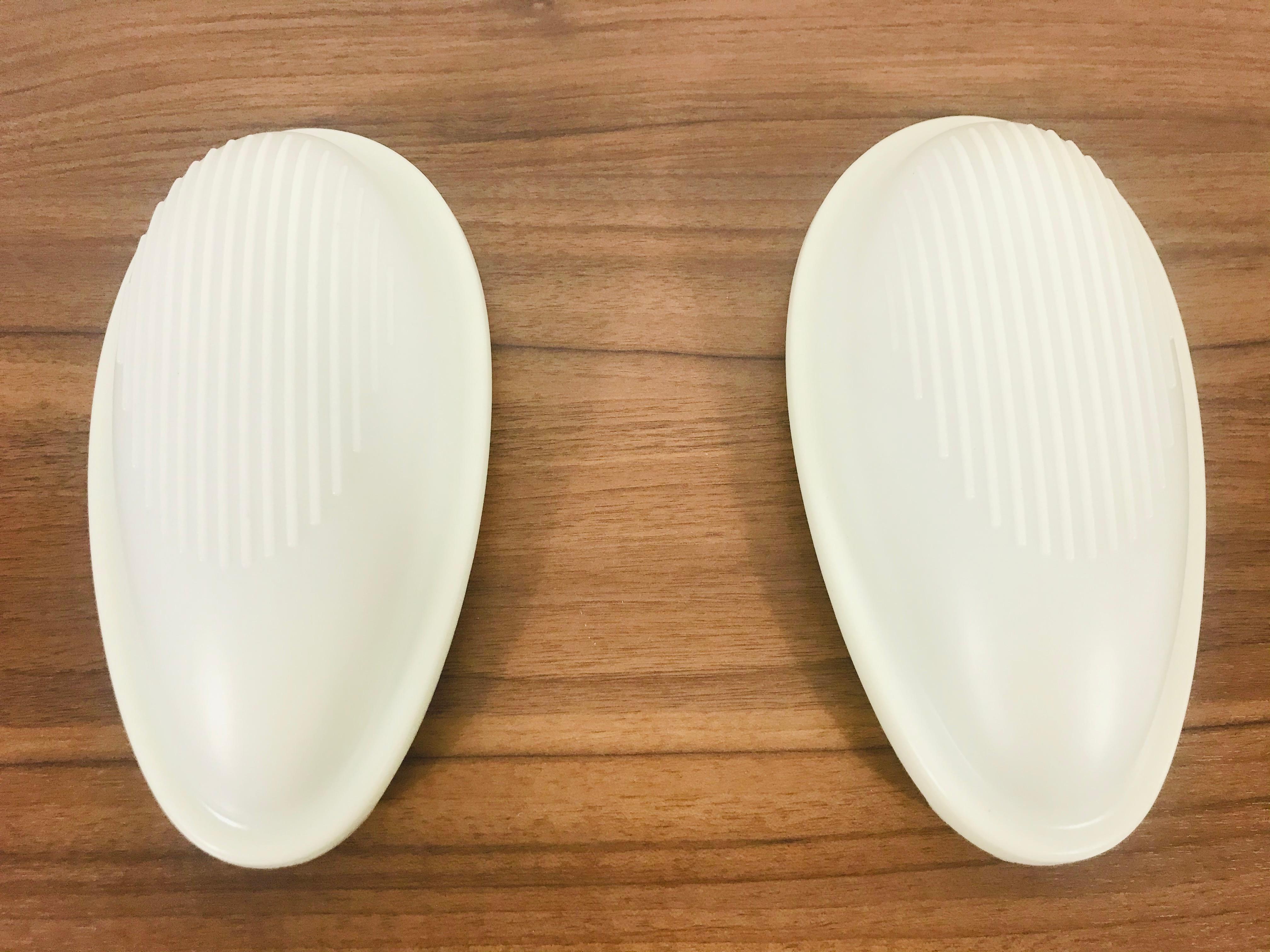 A pair of wall lamps by Marc Sadler for Arteluce made in Italy in 1993. The shade of the lamp is made of silicon and has a beautiful white color. The base is made of hard plastic.
 