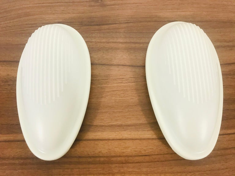 A pair of wall lamps by Marc Sadler for Arteluce made in Italy in 1993. The shade of the lamp is made of silicon and has a beautiful white color. The base is made of hard plastic.
 