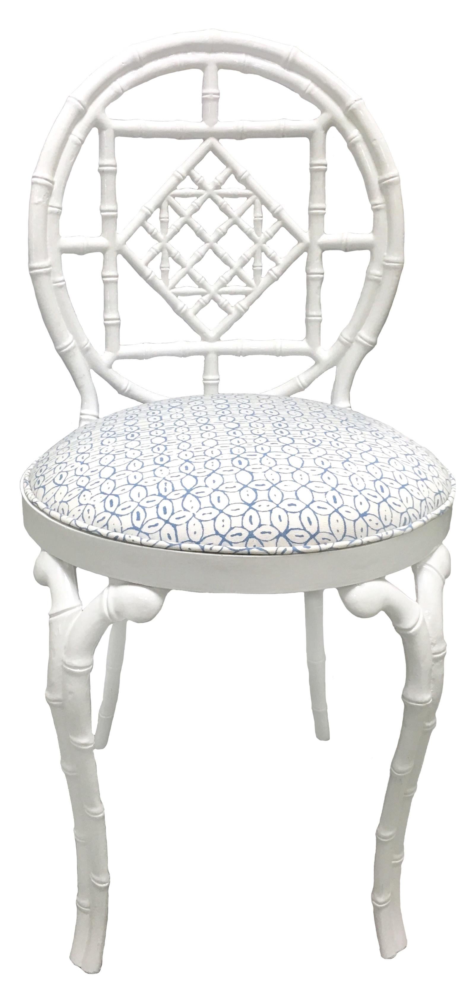 Pair of faux bamboo metal chairs by Kessler. Newly refinished in white powder coated finish. Newly upholstered in Quadrille Melong Batik suncloth fabric in white/light blue. Suitable for indoor or outdoor use. Signed 