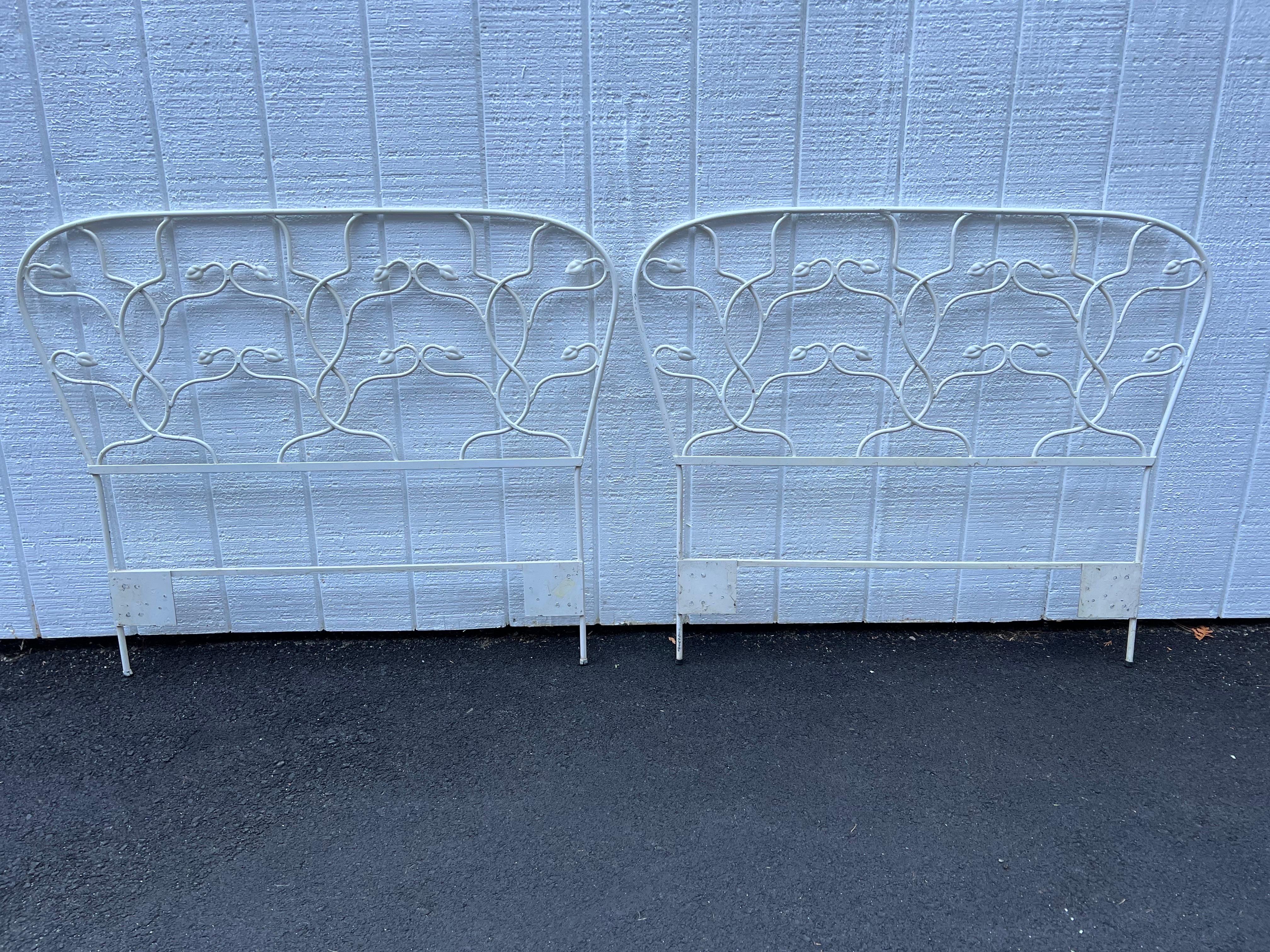 Pair of white floral iron twin headboards signed Salterini. Nice decorative design. Perfect for that little girls bedroom. Signed on back. Or be creative and use as a trellis in a garden. Shabby chic in style.
