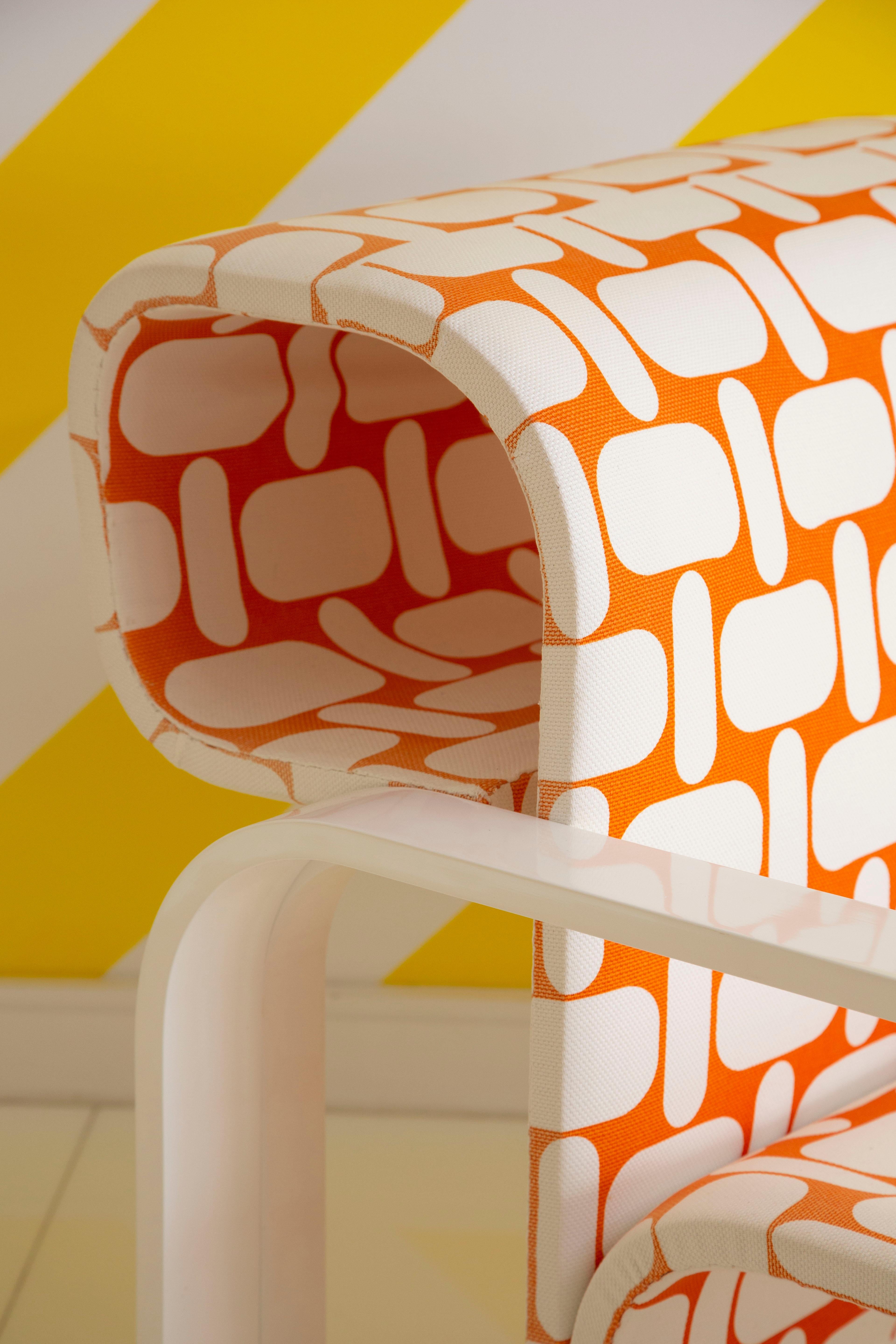 Pair of white framed armchairs with orange print fabric. Designed by award-winning architect Jan Bocan.
 