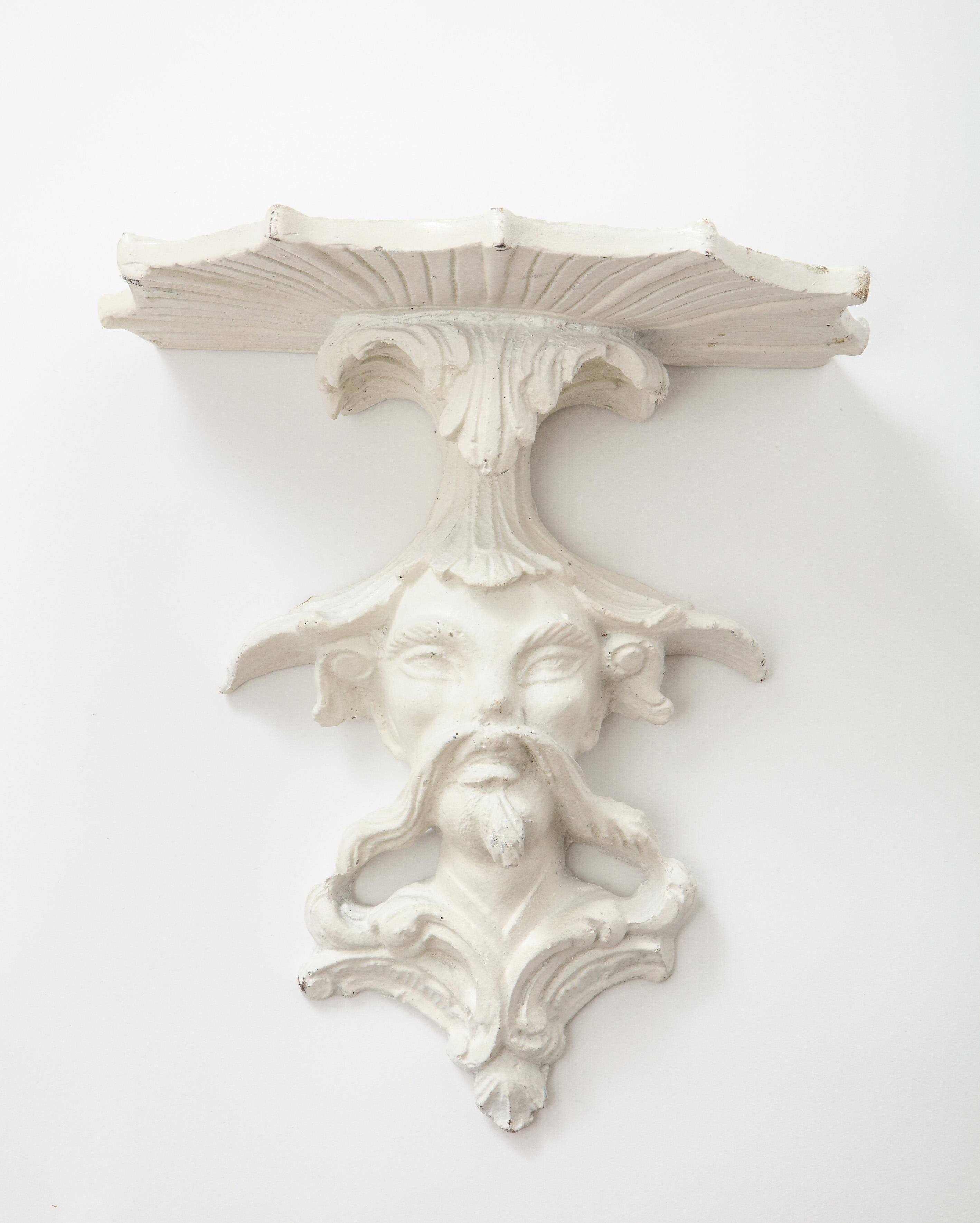 A fanciful concoction in the Brighton Pavilion style with each incorporating a bust of a Chinese court figure surmounted by a foliate spray supporting a fan-shaped shelf. Made of wood coated in gesso.