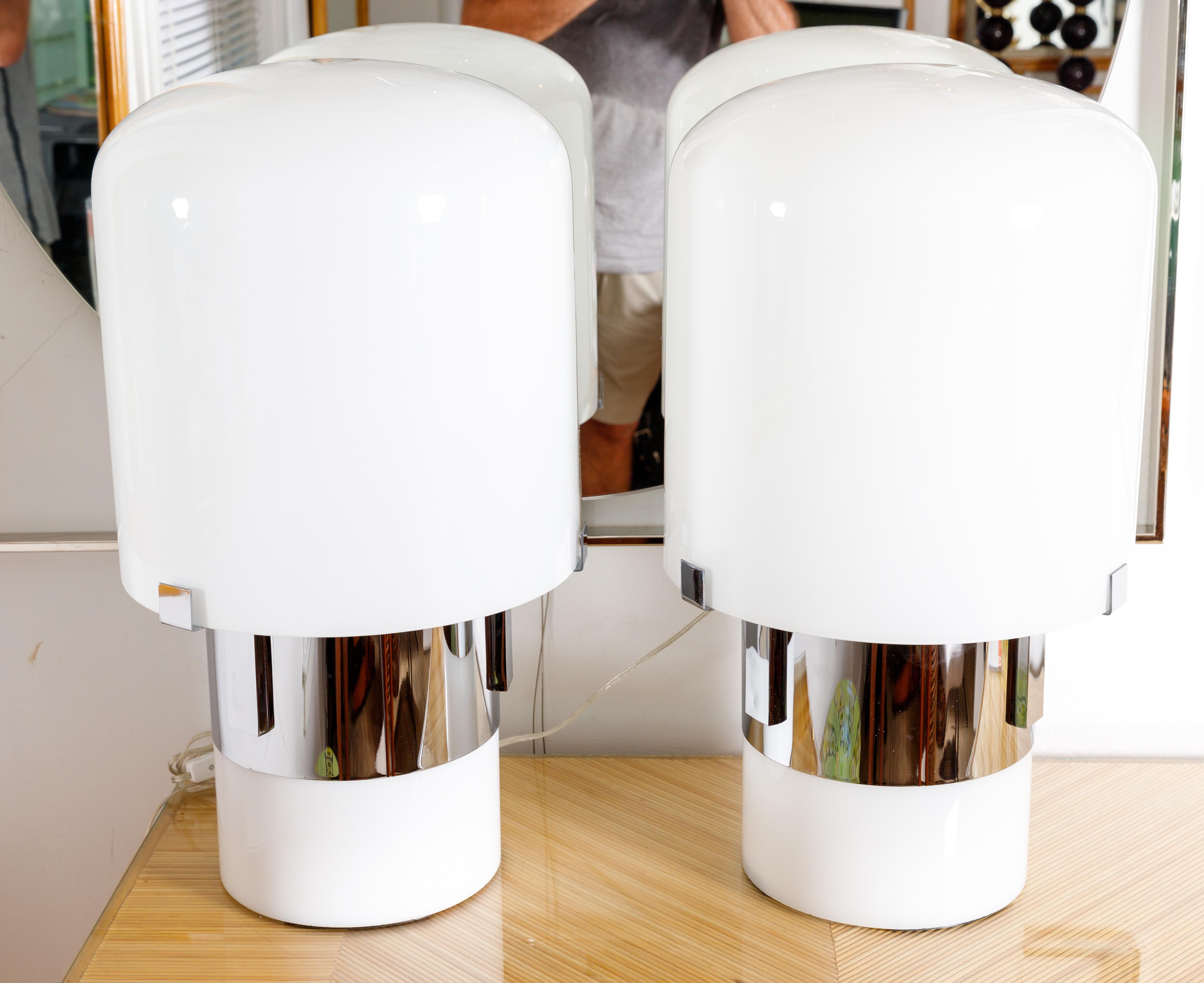 Pair of white glass, chrome & lucite cylindrical table lamps with interior base light.