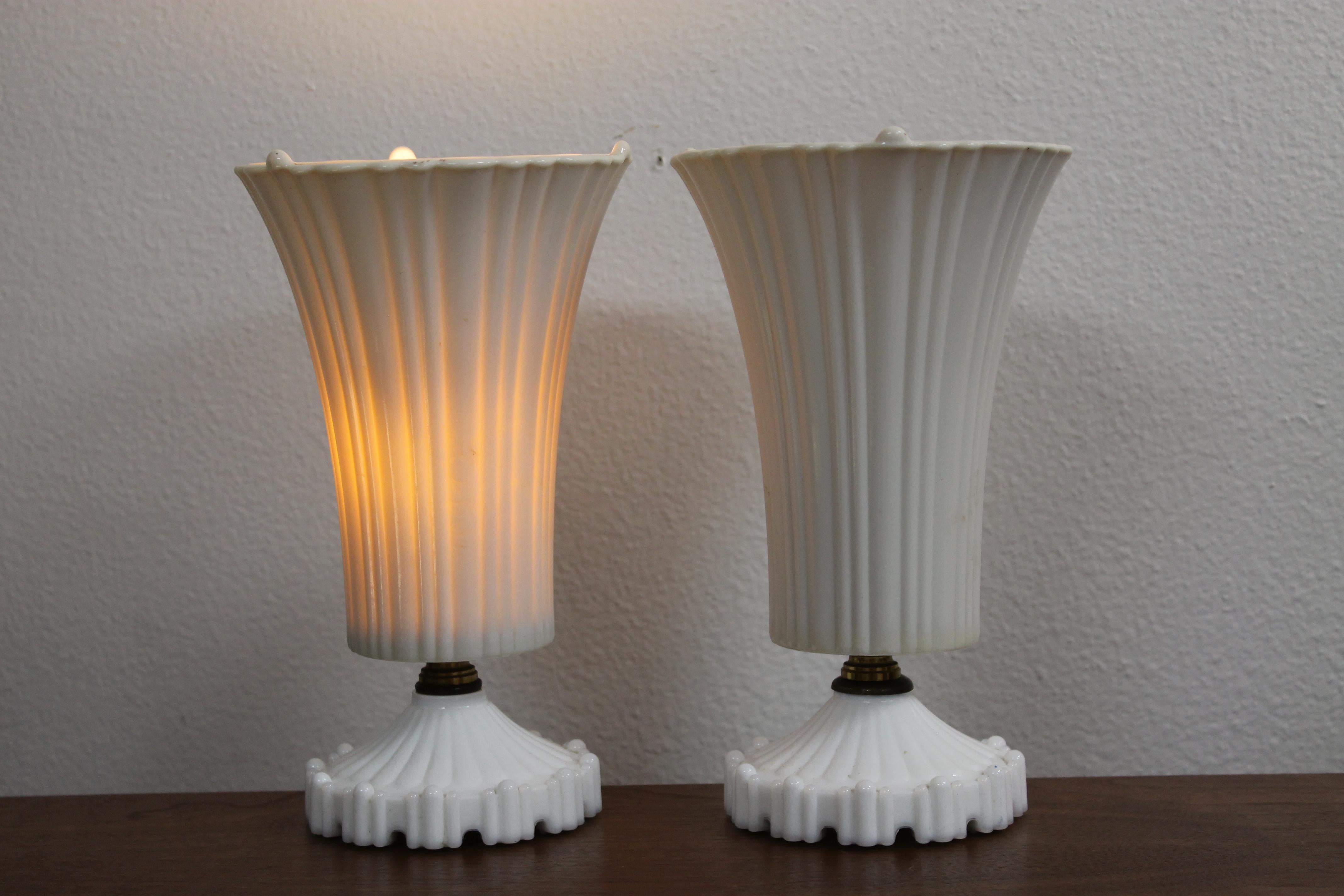 Pair of Art Deco white glass lamps. Lamps have been professionally rewired and use a candelabra light bulb. Each lamp measures 10