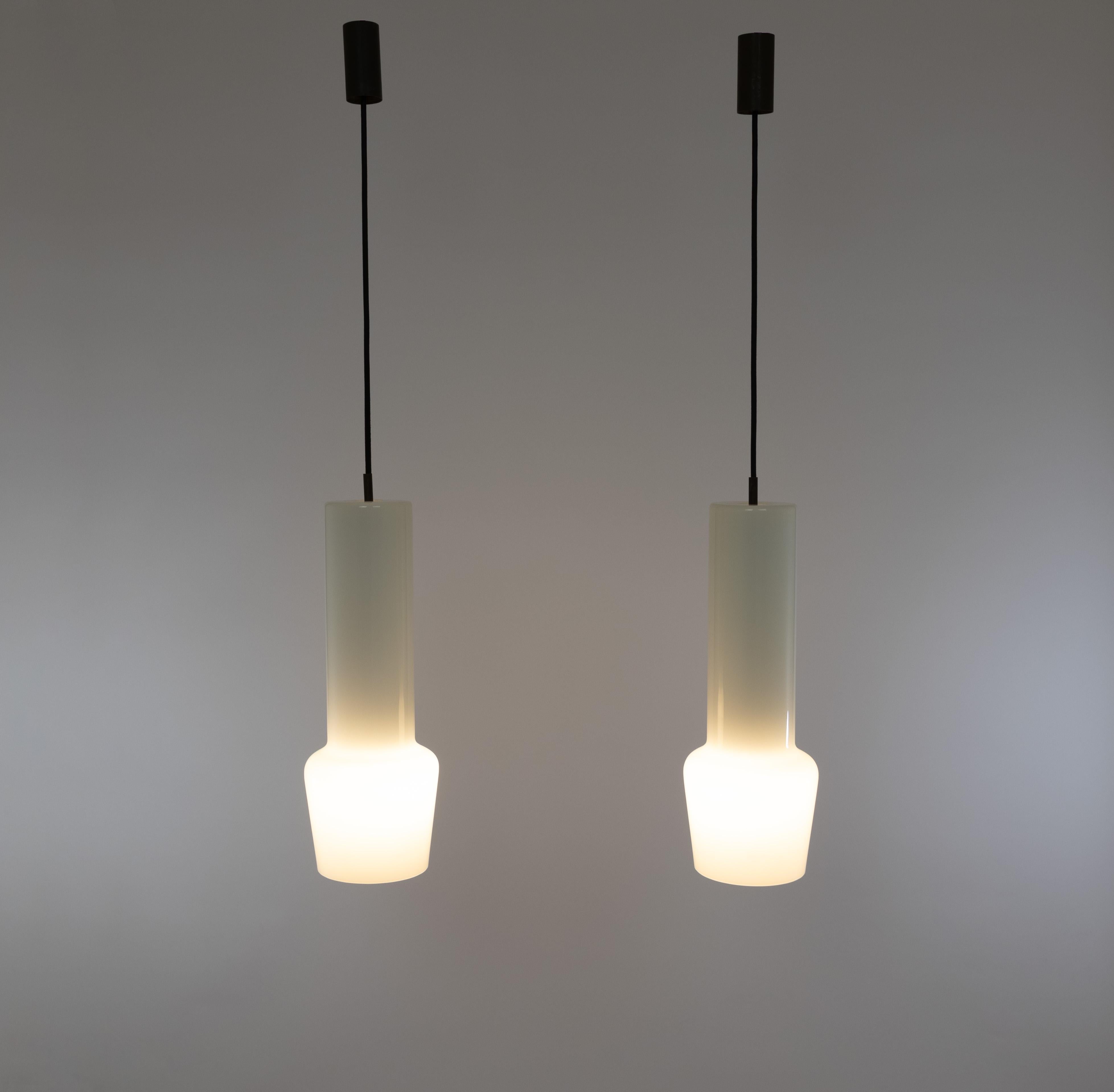 Una coppia di pendenti in vetro bianco soffiato a mano no. 011.11, disegnati da Massimo Vignelli all'inizio della sua impressionante carriera nel mondo del design e realizzati dallo specialista del vetro di Murano Venini. 

È uno dei modelli più