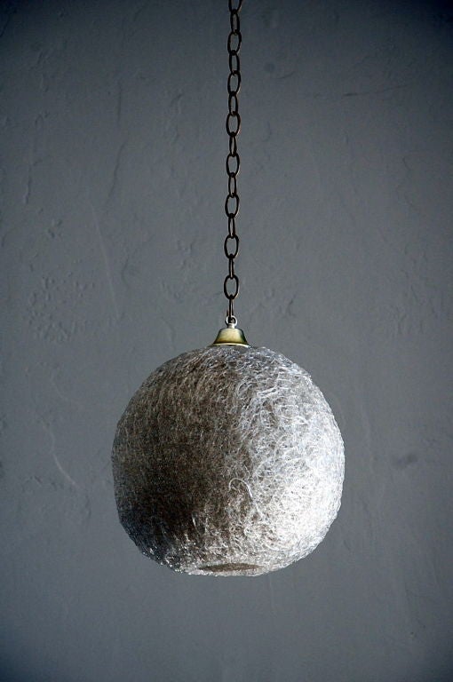 Pair of white glass thread globe hanging lights.