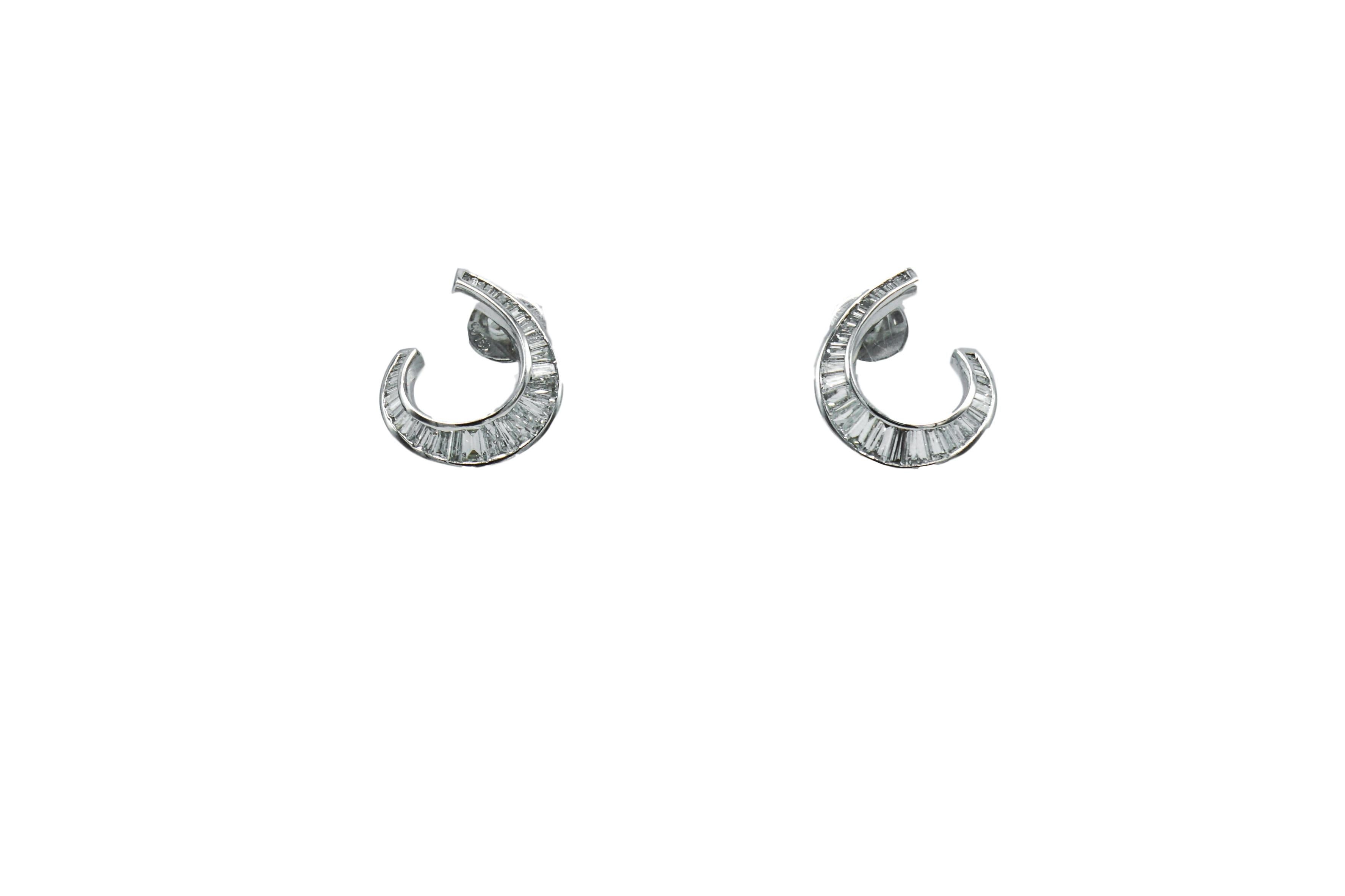 Pair of White Gold and Diamond Earrings
18 kt., 66 baguette diamonds ap. 2.25 cts., ap. 5.5 dwts.   

Diamonds: H-I-VS, several SI. 

Posts. 7/8 x 11/16 inch. 

SKU#E-01174