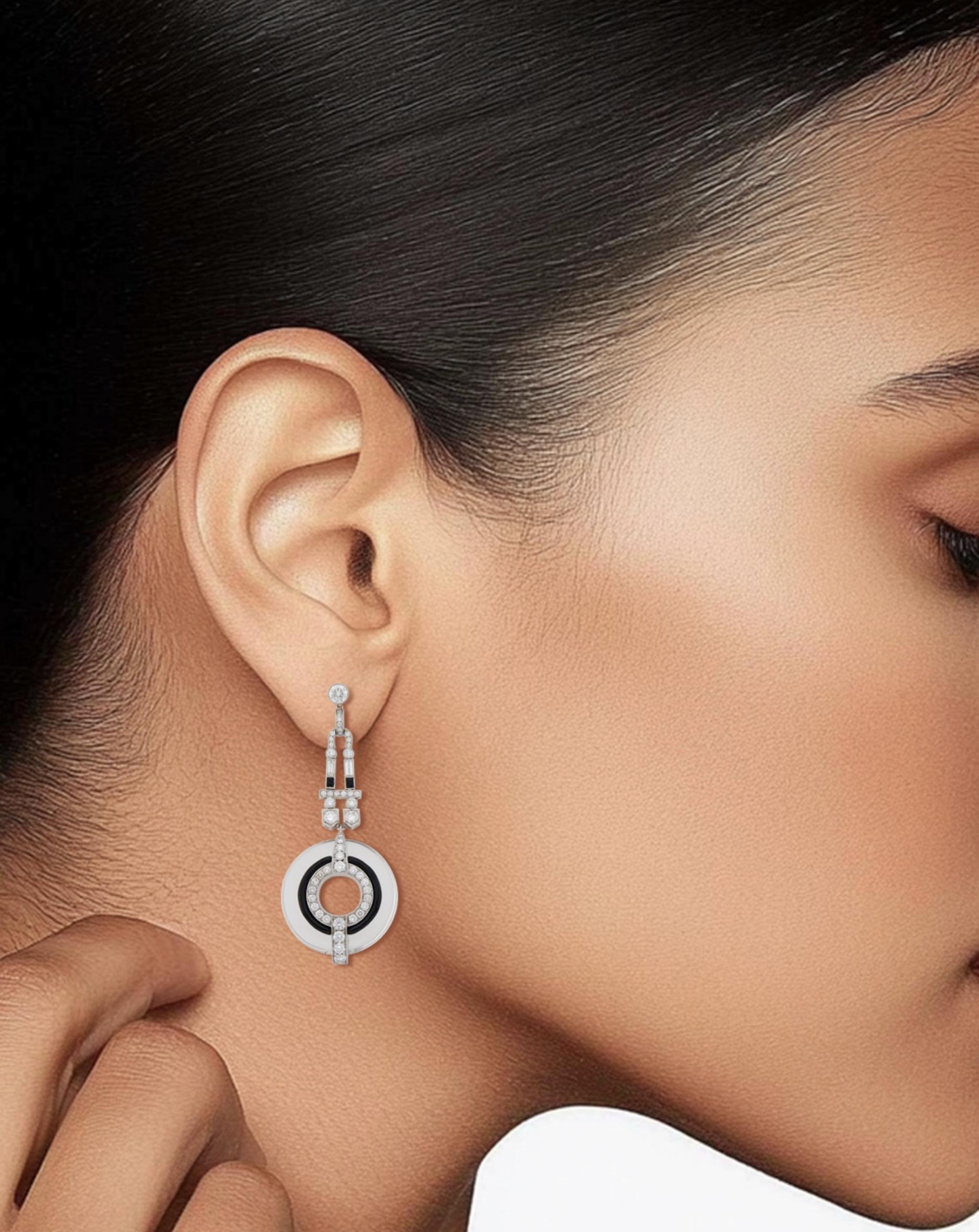 Pair of White Gold, Rock Crystal, Diamond and Black Enamel Pendant-Earrings

Details:
100 round diamonds ap. 3.20 cts.
Weight of the pair: 28.2 grams
Length: 2.36 inches

In excellent condition