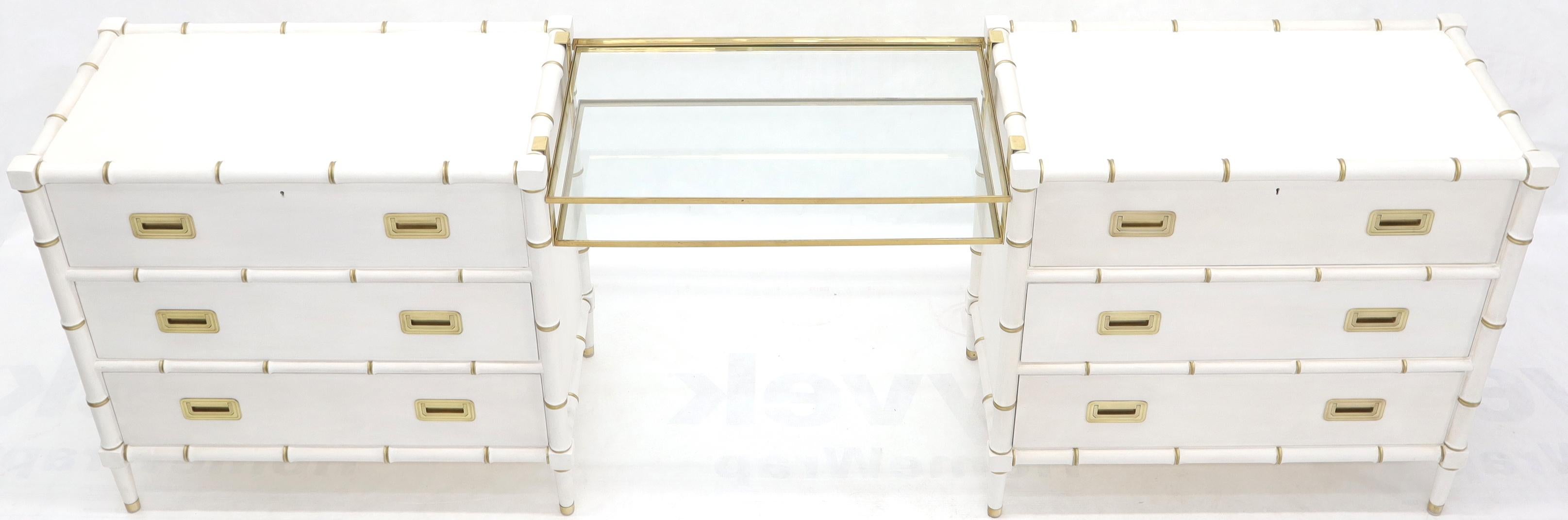 Coppia molto decorativa di comò in finto bambù laccato bianco collegati a un vanity sospeso in ottone massiccio di Baker. La lunghezza complessiva della 