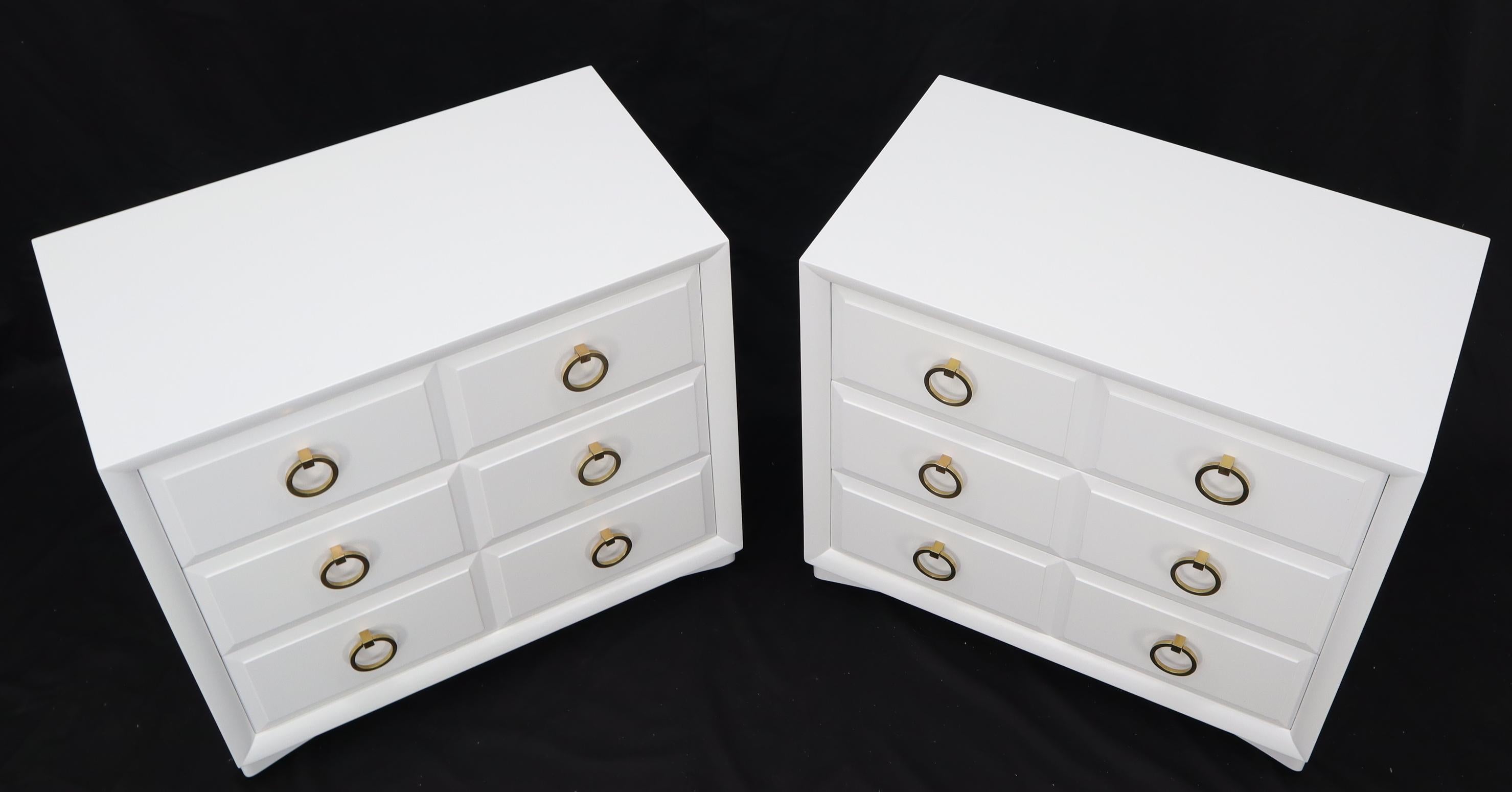 Pair of iconic Mid-Century Modern bachelor chests dressers cabinets designed by Robsjohn Gibbings for Widdicomb. Heavy solid brass ring drawer pulls.