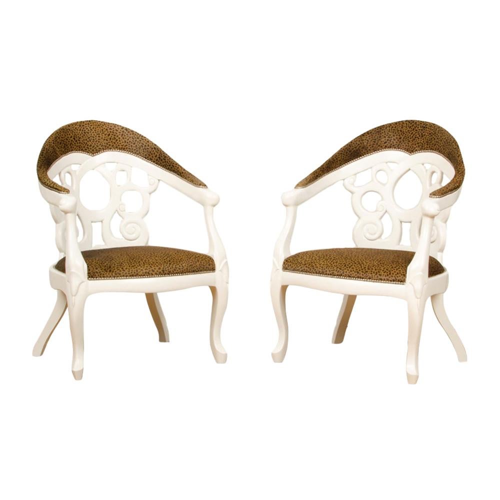 A pair of white lacquered armchairs designed by D.Barrett, circa 1970. Upholstered in leopard fabric.
  