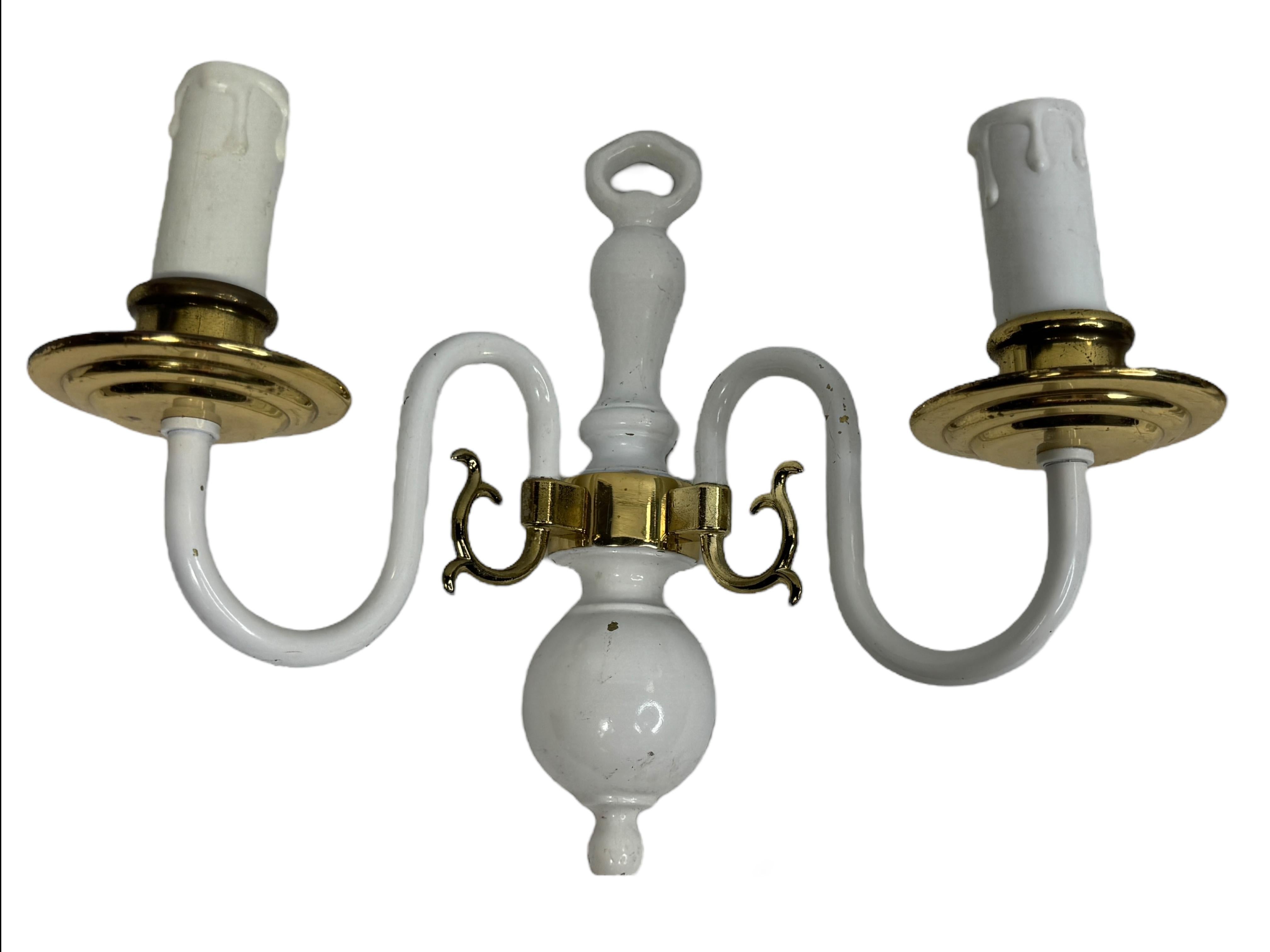 A stunning pair of heavy brass wall sconces. Each consisting of a stylish Farmhouse style design. Each fixture requires two European E14 / 110 Volt candelabra bulbs, each bulb up to 40 watts. A nice addition to any room, but we think it will be a